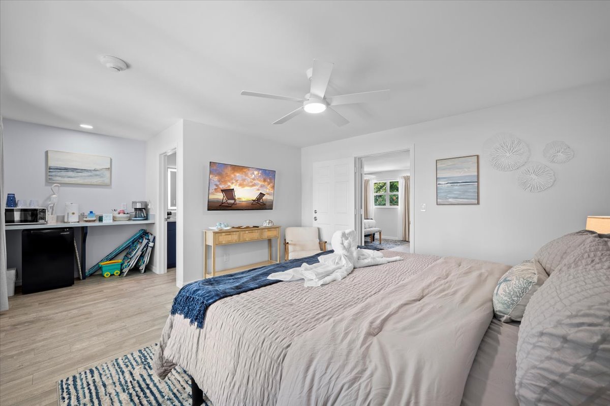 Bright coastal-style bedroom with kitchenette and spacious, airy layout