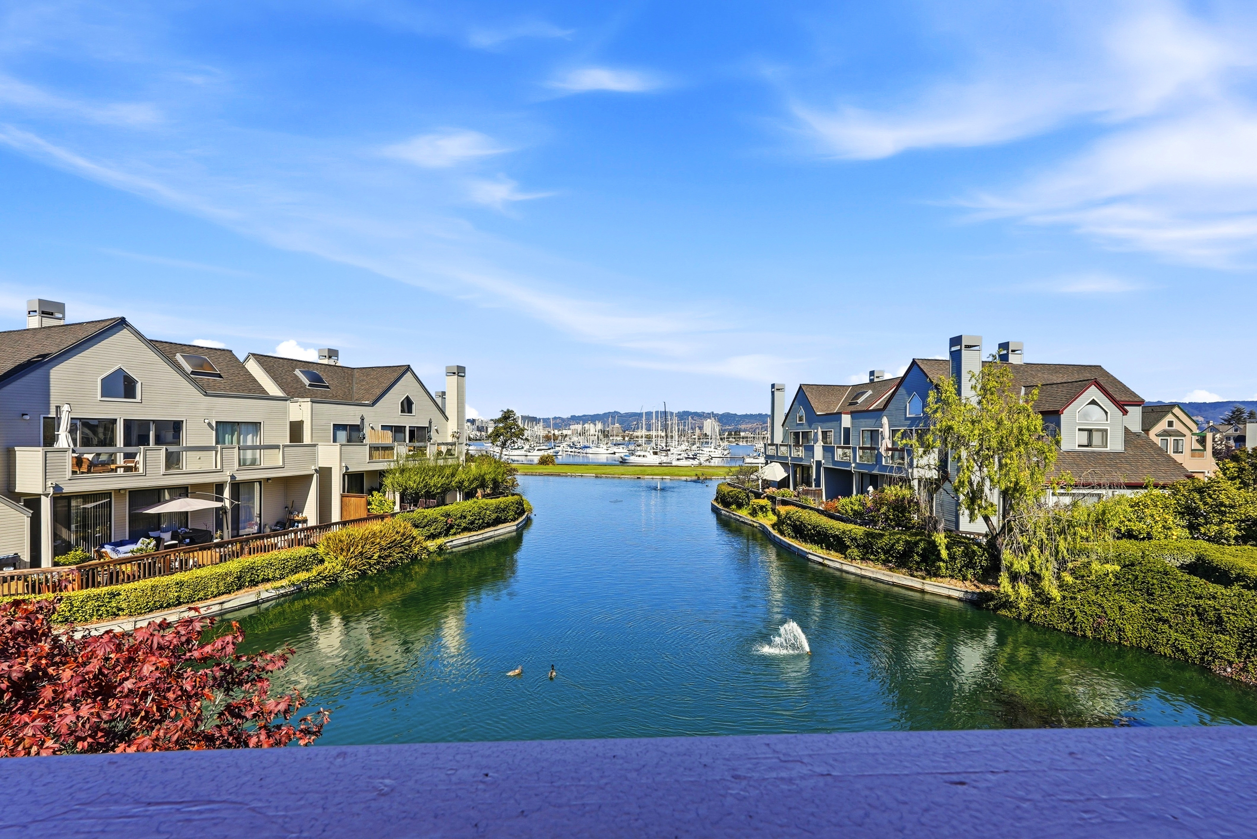 Scenic waterfront canal views with marina backdrop and peaceful charm