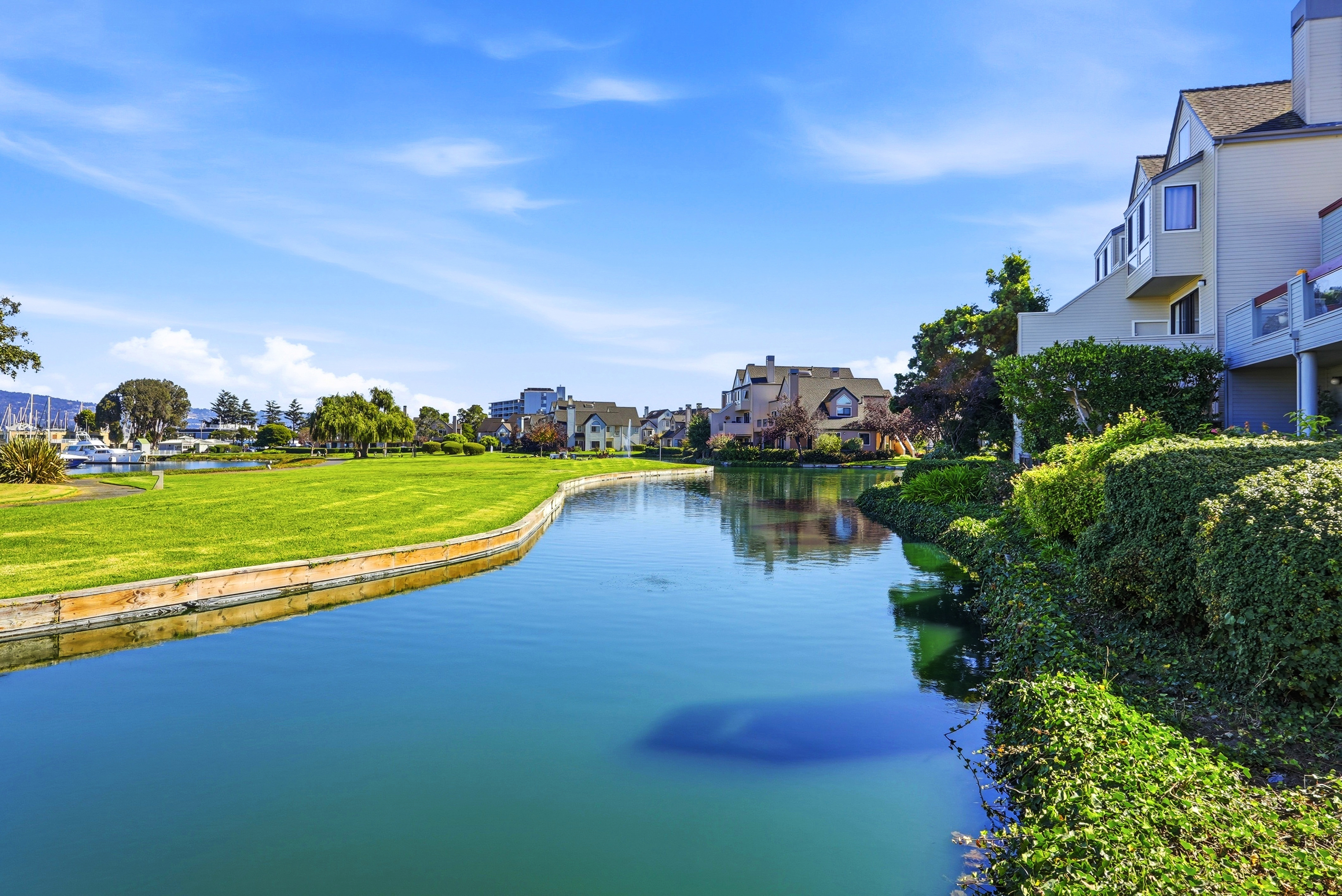 Serene waterfront setting with lush grounds and scenic neighborhood views