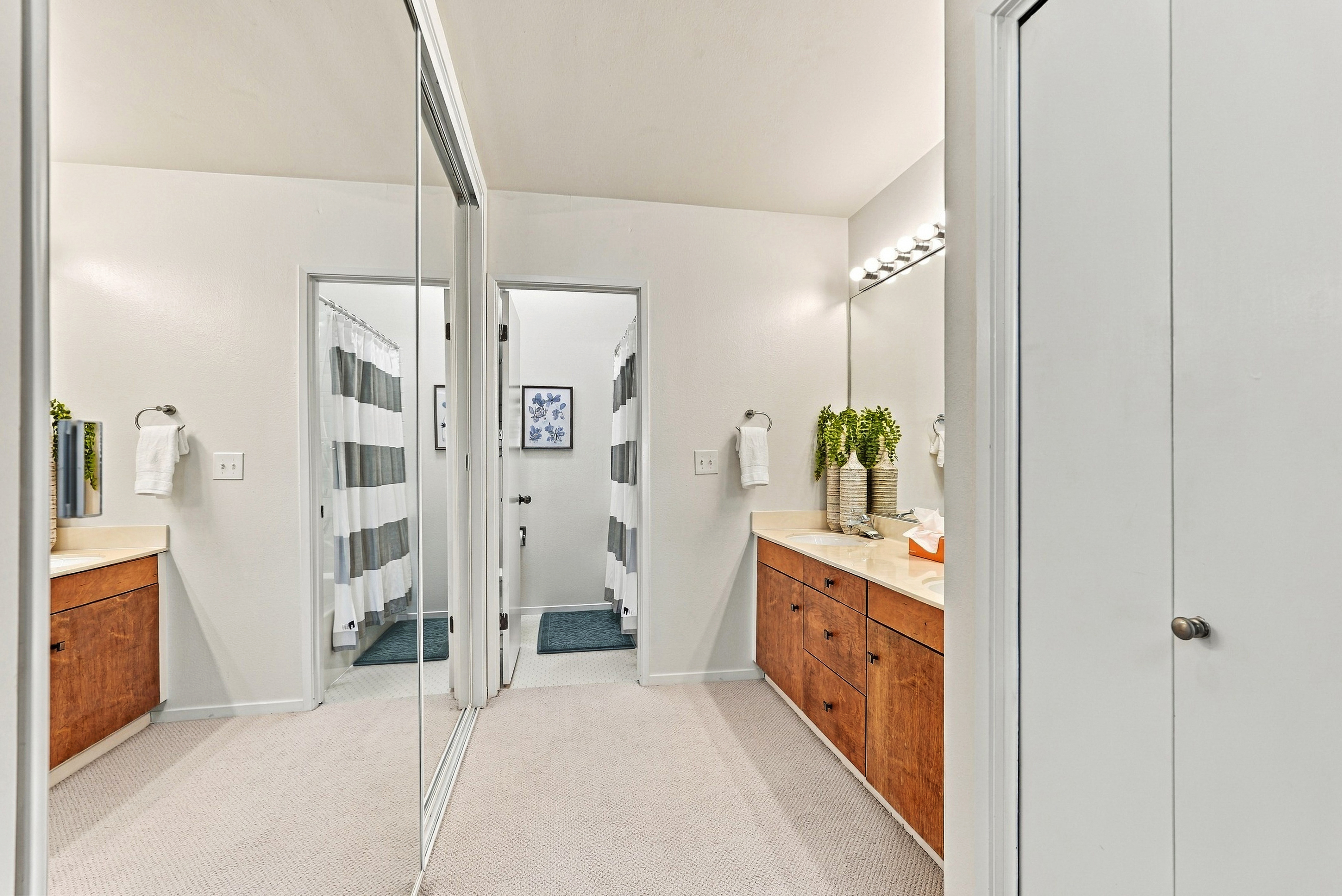 Bright, spacious bathroom with large mirrors and generous vanity space
