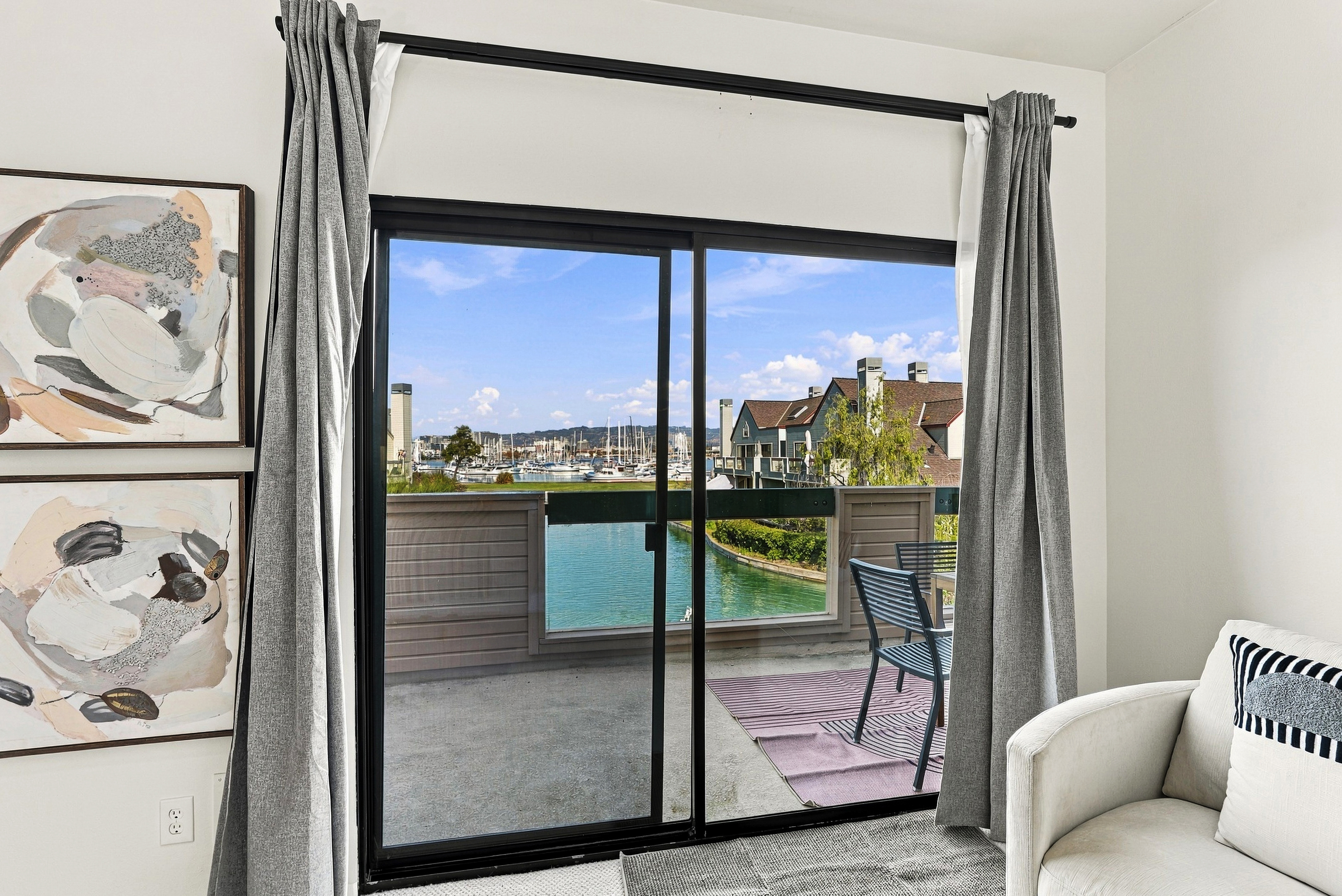 Private balcony with serene water views and bright, airy interiors