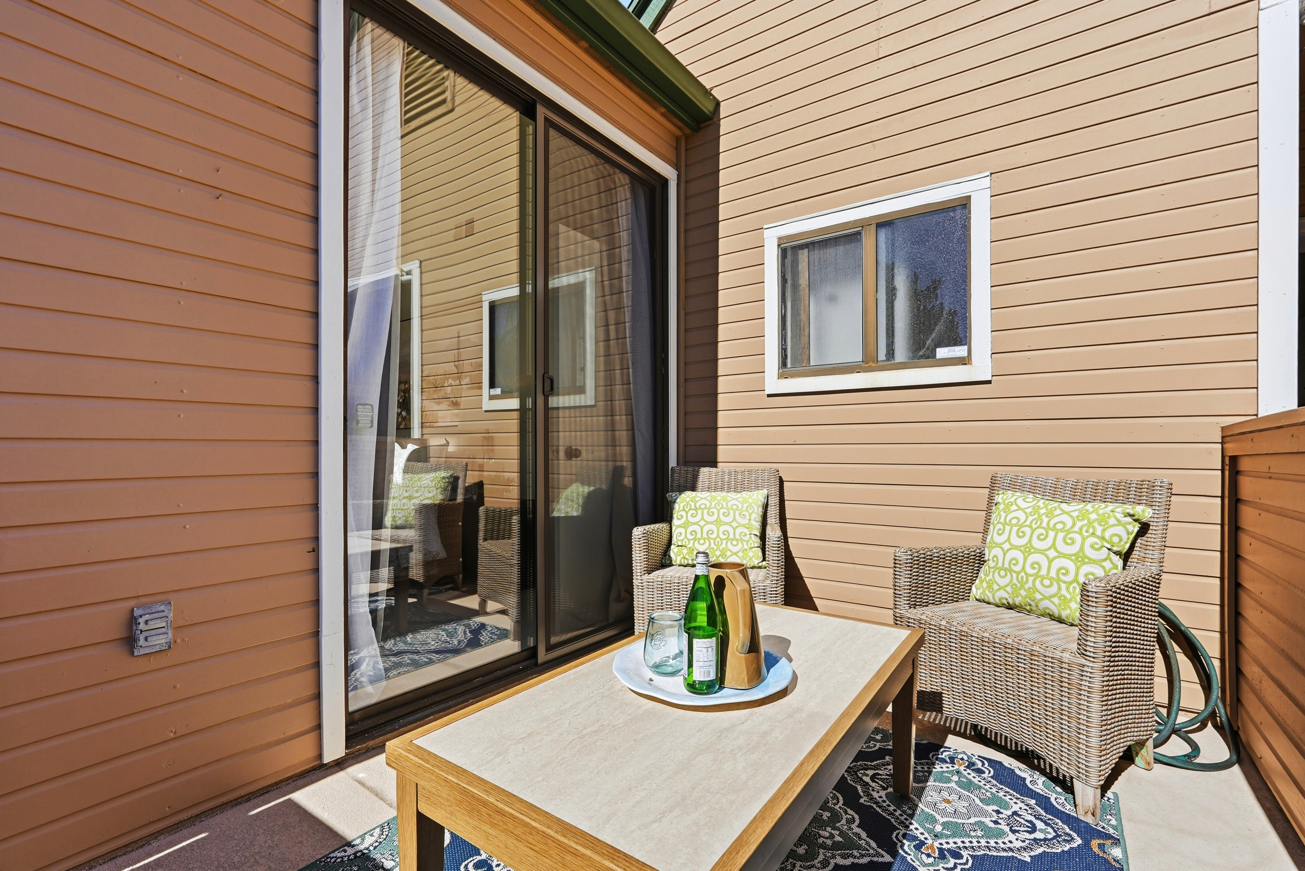 Cozy private patio with lounge seating and sliding door access