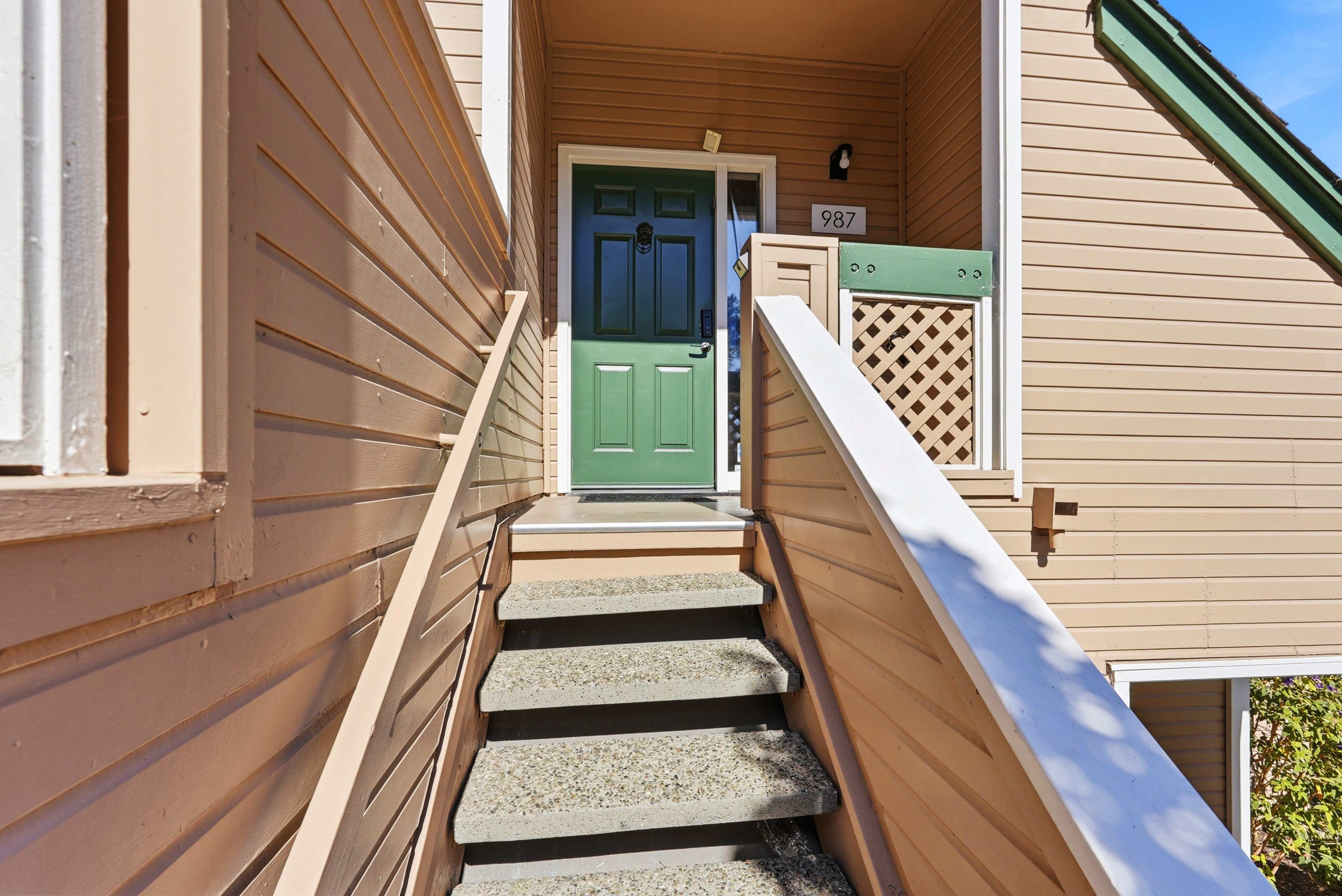 Private covered entry with charming green front door
