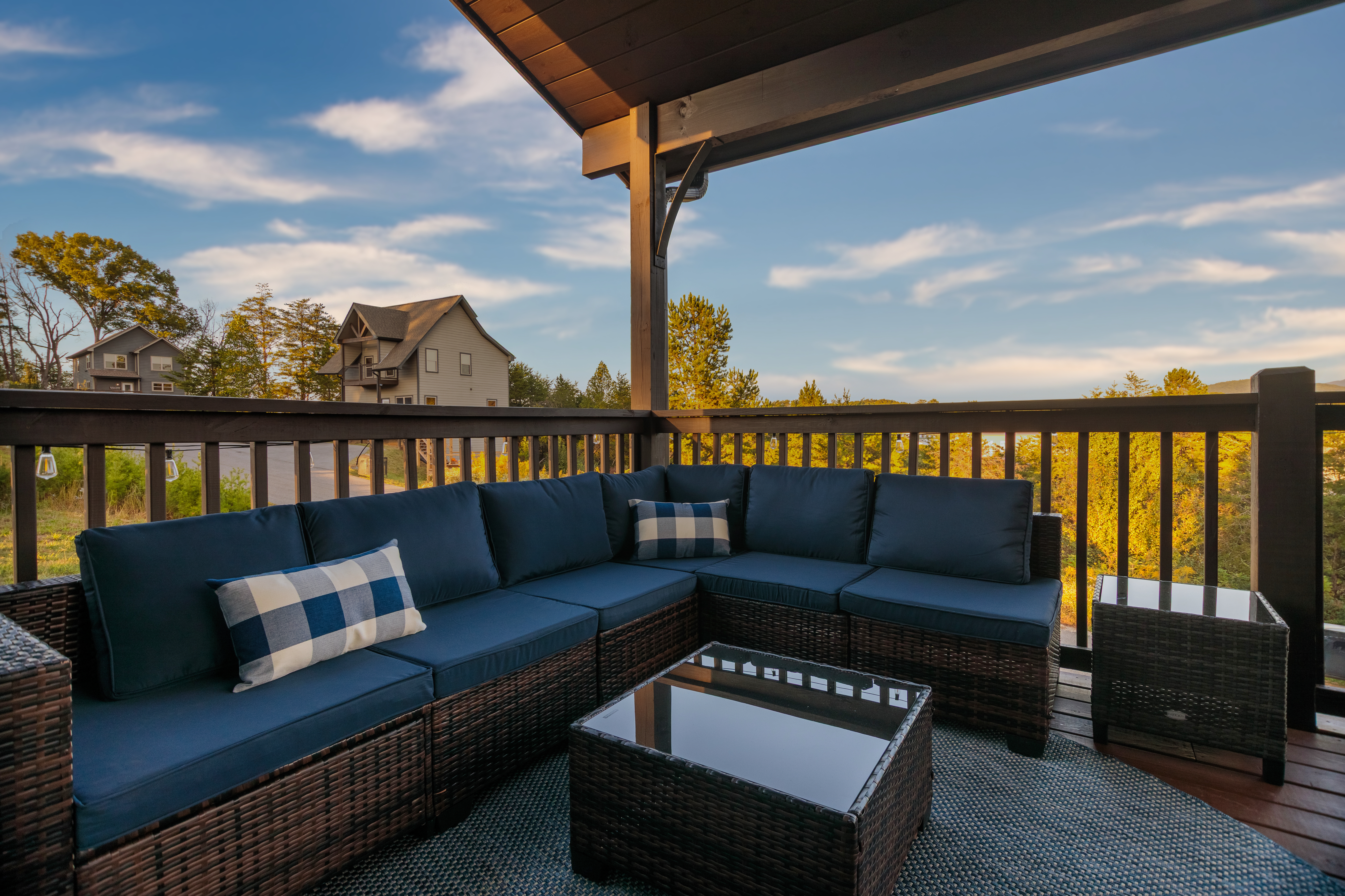 Covered deck with cozy sectional seating and serene treetop views