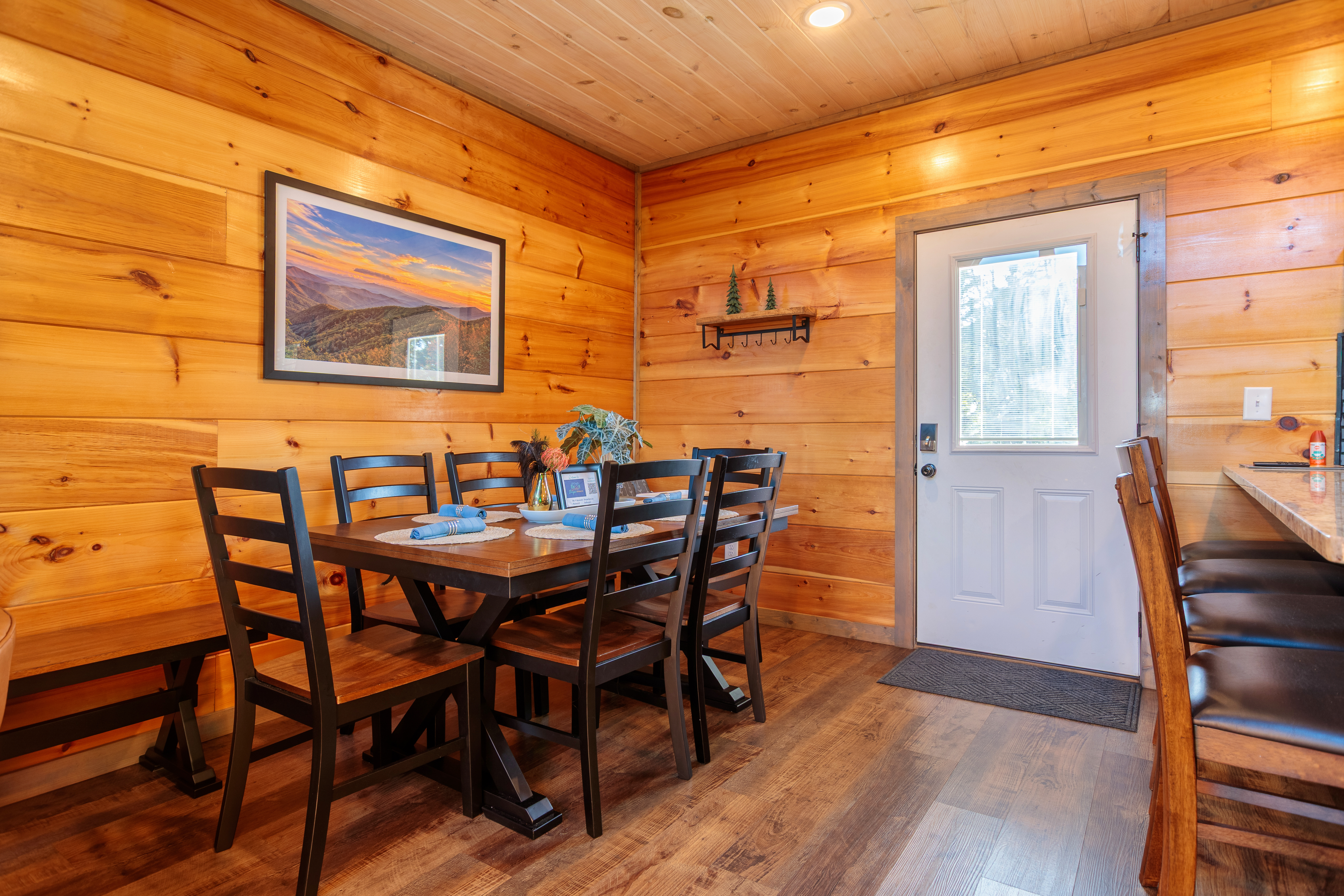 Cozy wood-lined dining area with seating for 6 plus breakfast bar