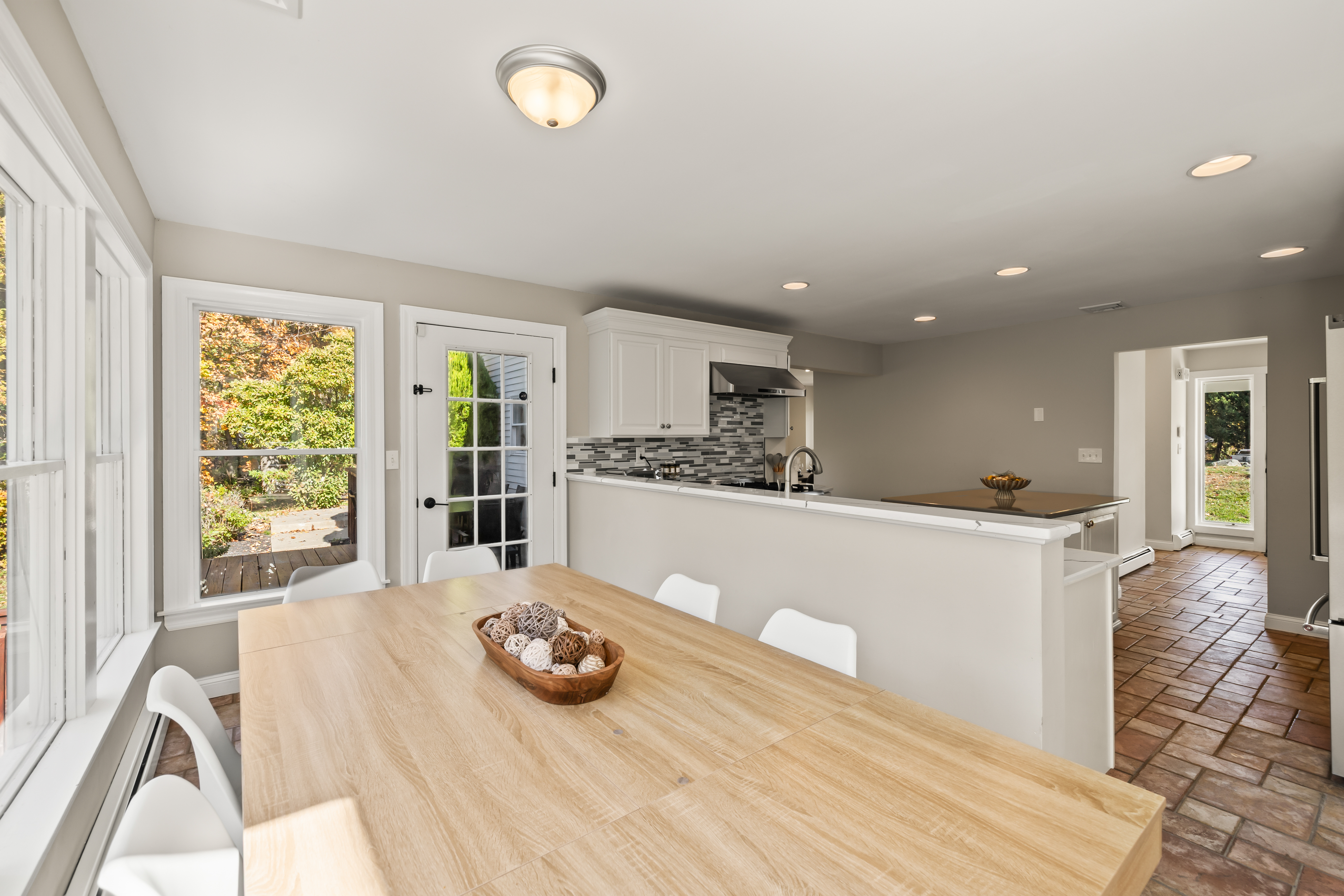 Bright open dining area with breakfast bar and easy outdoor access