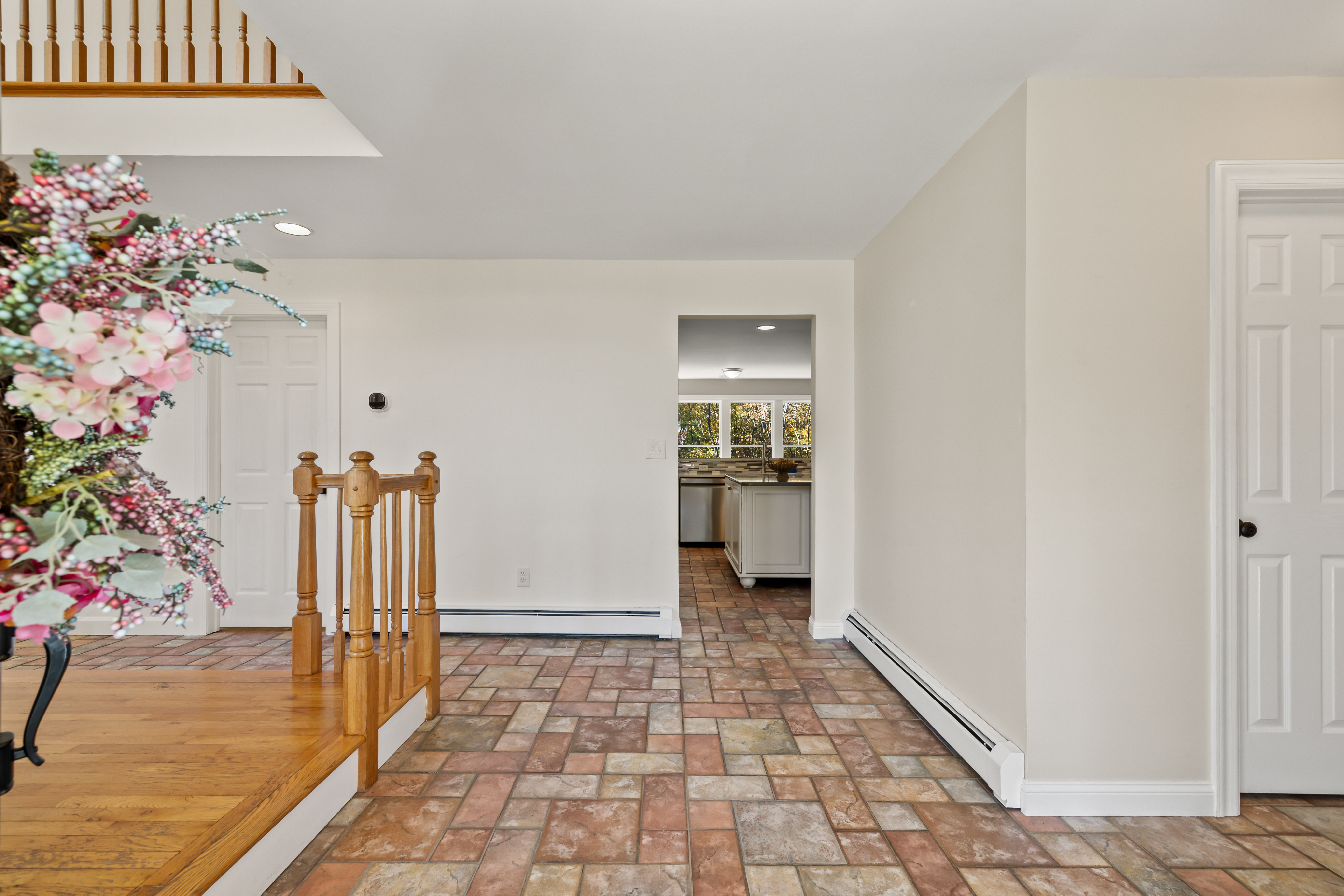 Bright, spacious entryway with tiled floors and easy flow to the kitchen