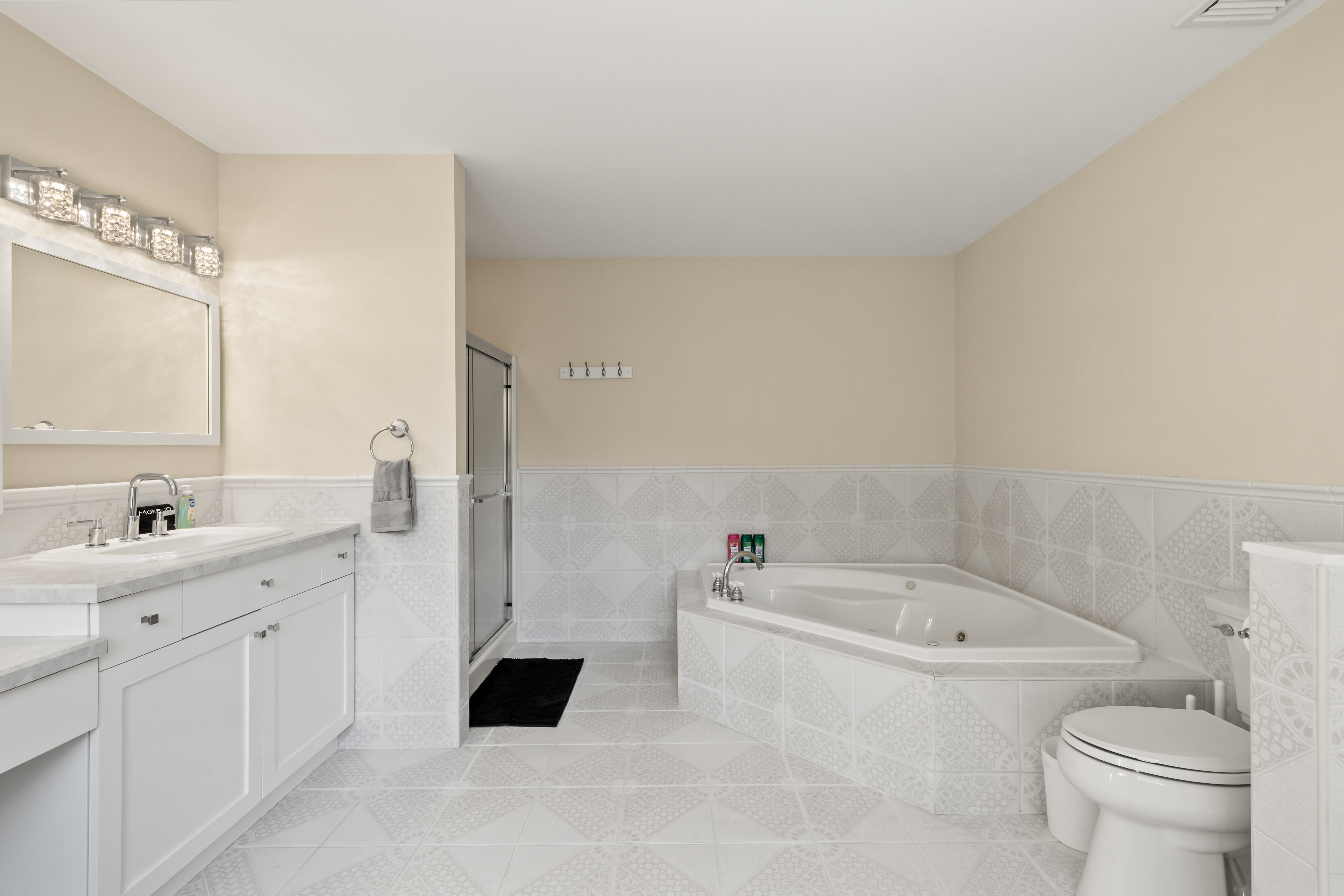 Bright, spacious bathroom with soaking tub, shower, and double vanity