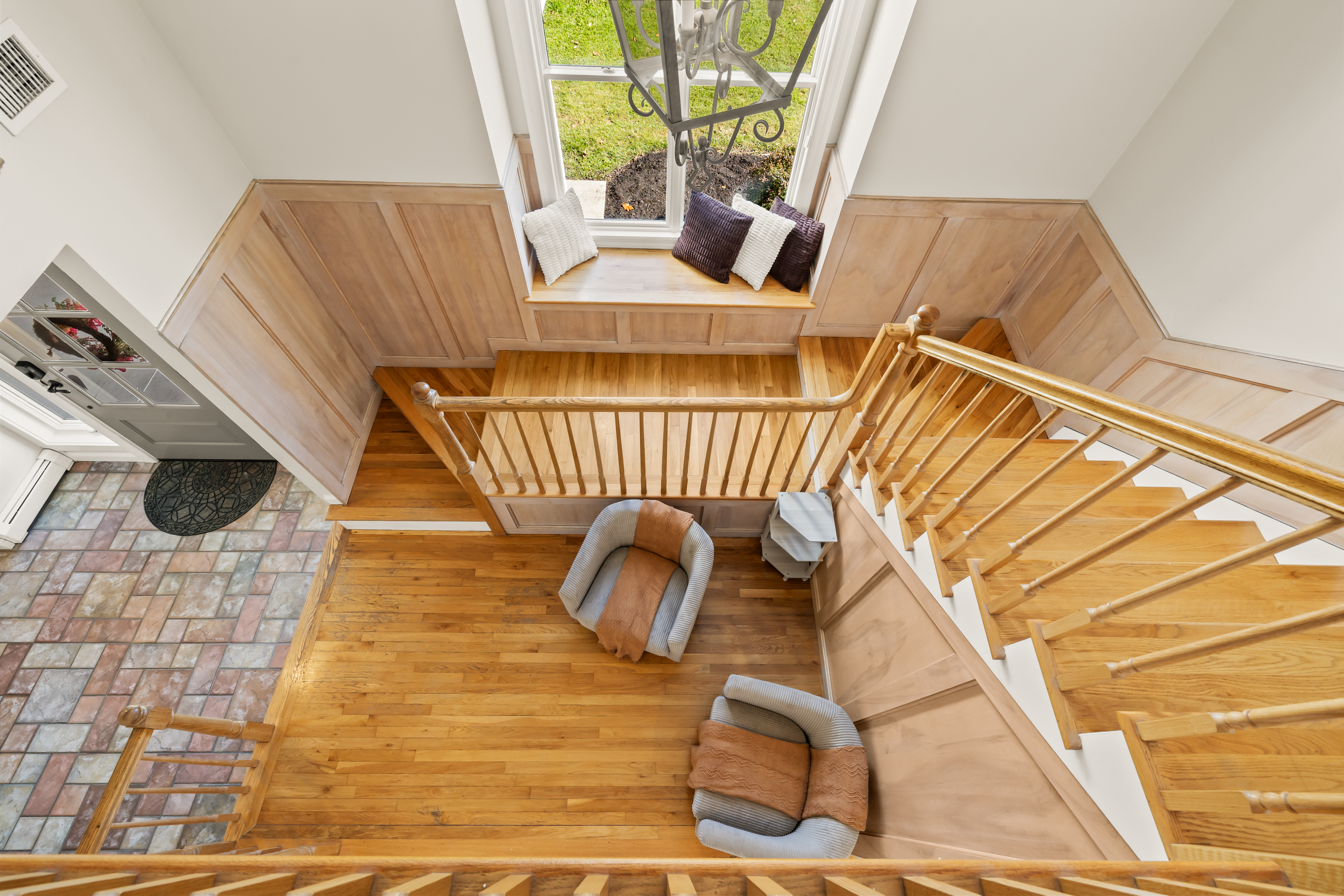 Bright grand entry with hardwood stairs and cozy window seat