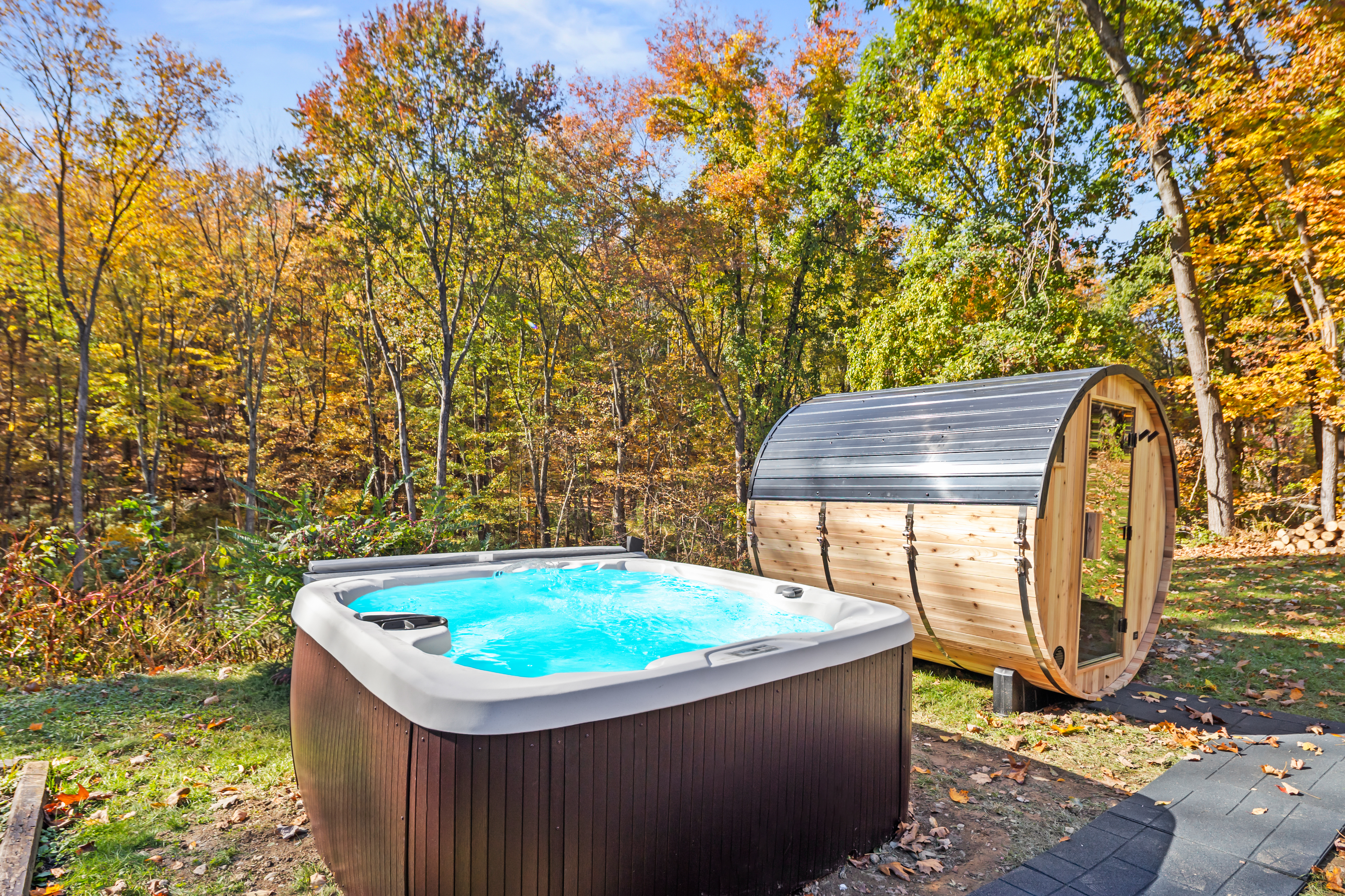 Private hot tub and barrel sauna nestled in a peaceful woodland setting
