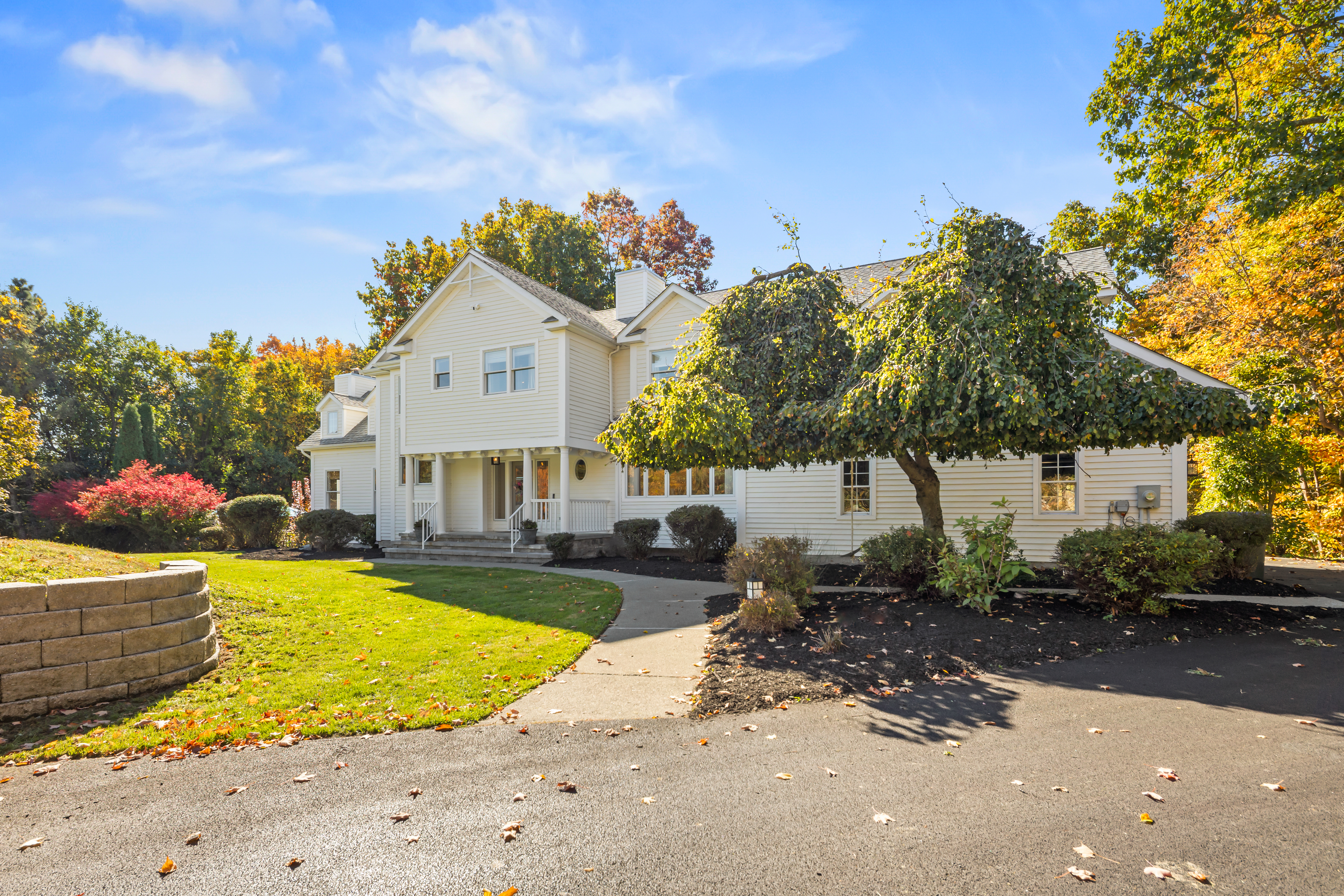 Spacious home with landscaped grounds, large driveway, and inviting entry