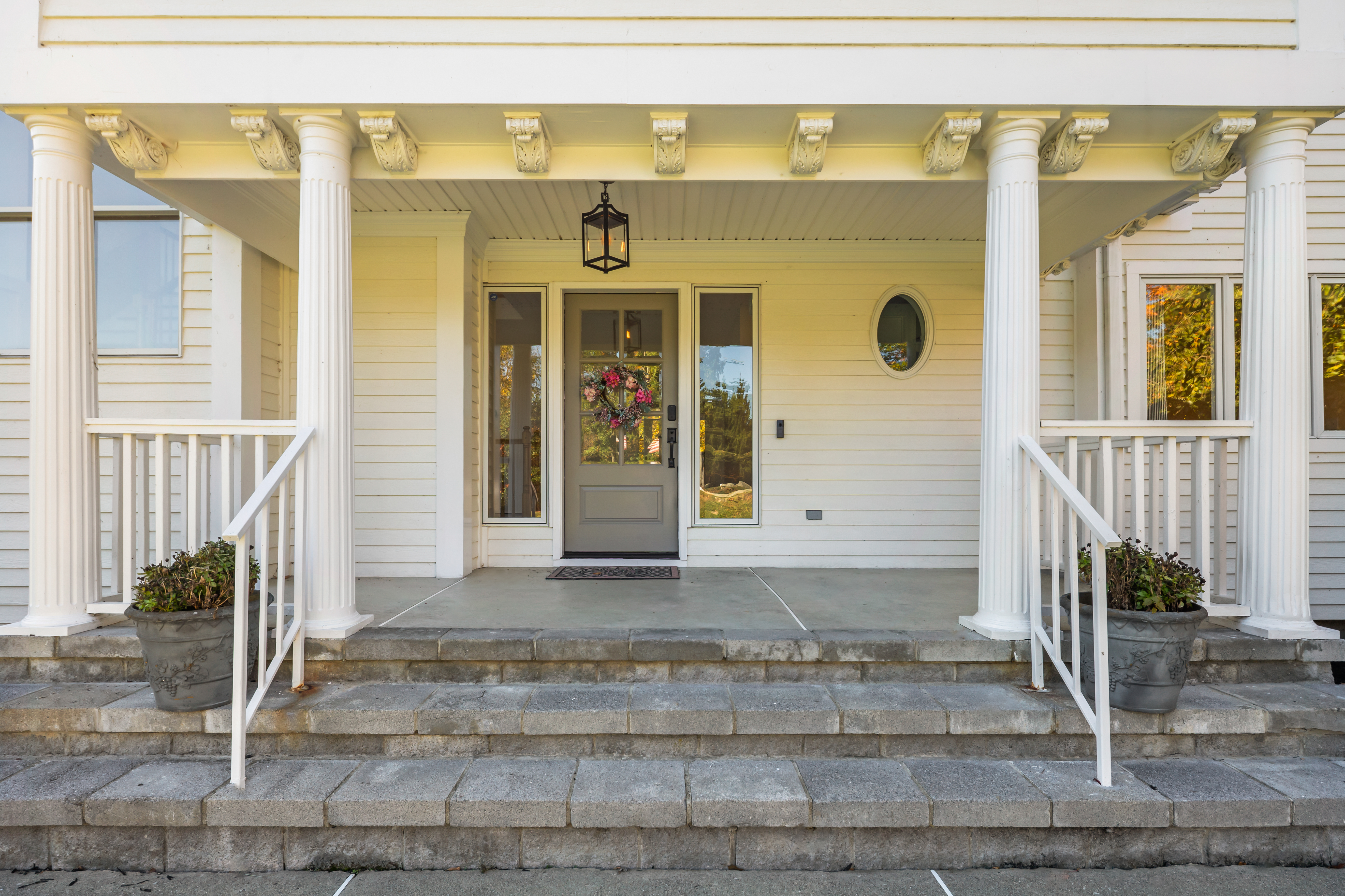 Grand front porch with stately columns and a warm, welcoming entry