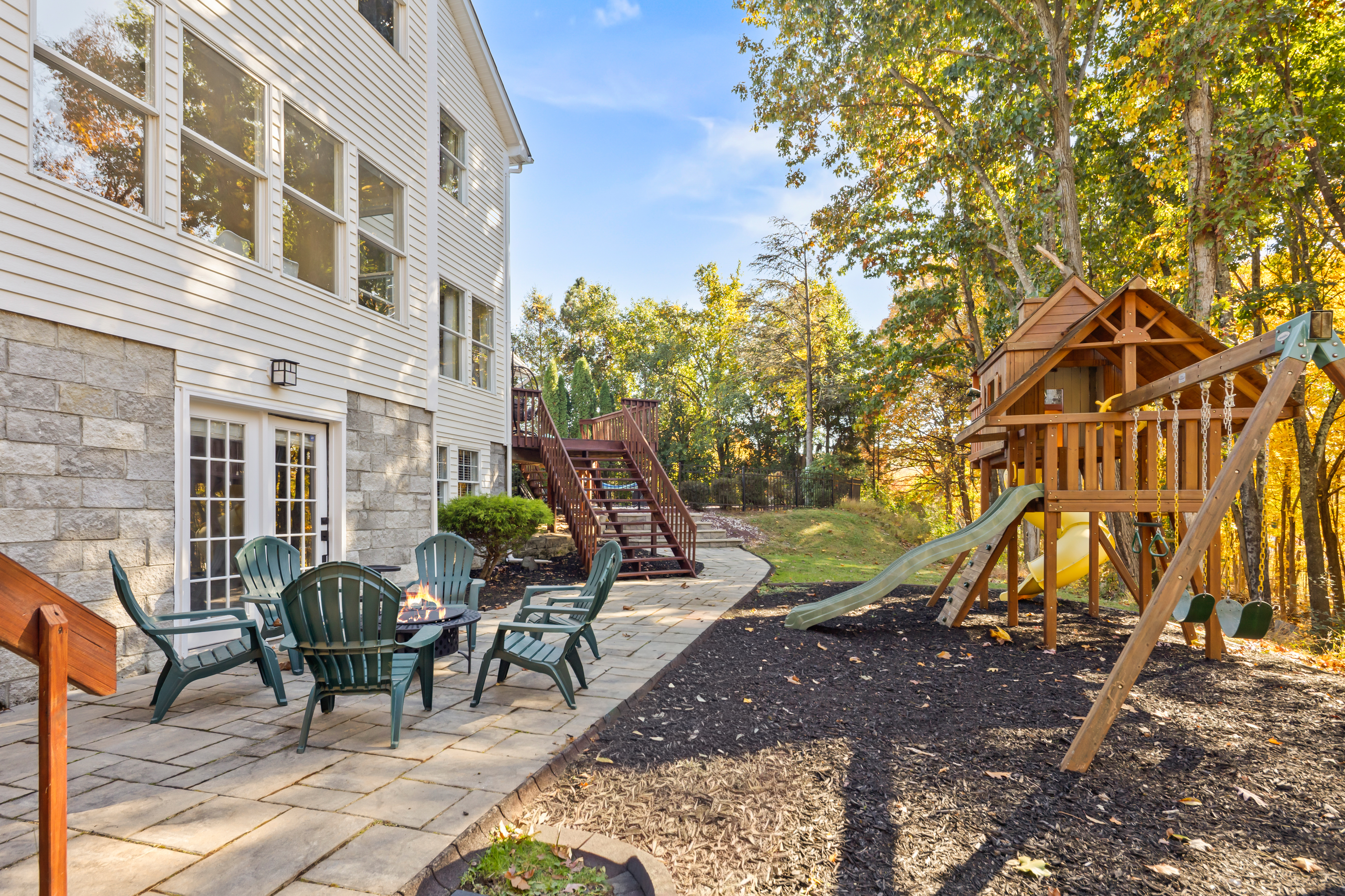 Family-friendly backyard with fire pit patio and private playset