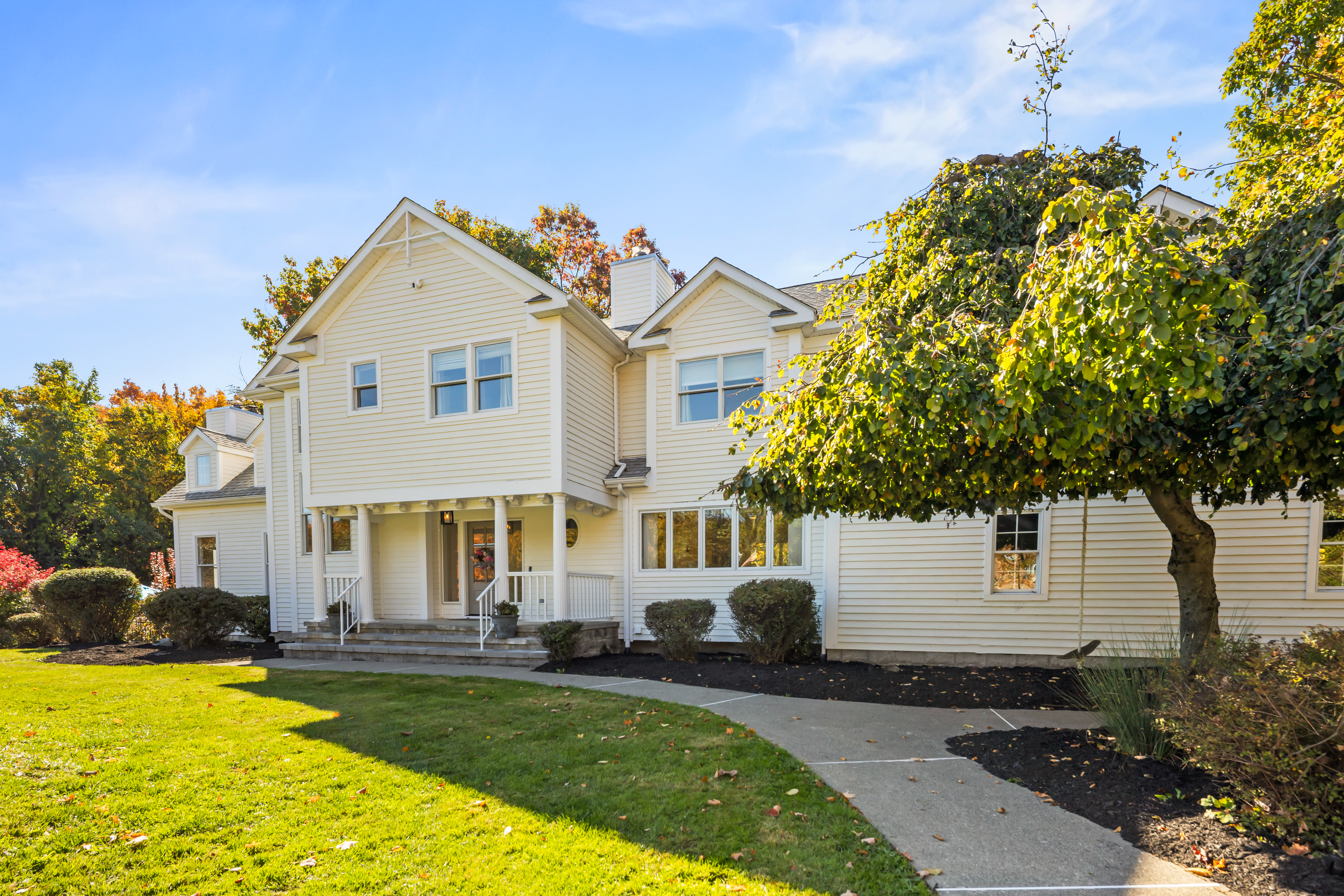 Welcoming exterior with landscaped grounds and a bright, spacious lawn