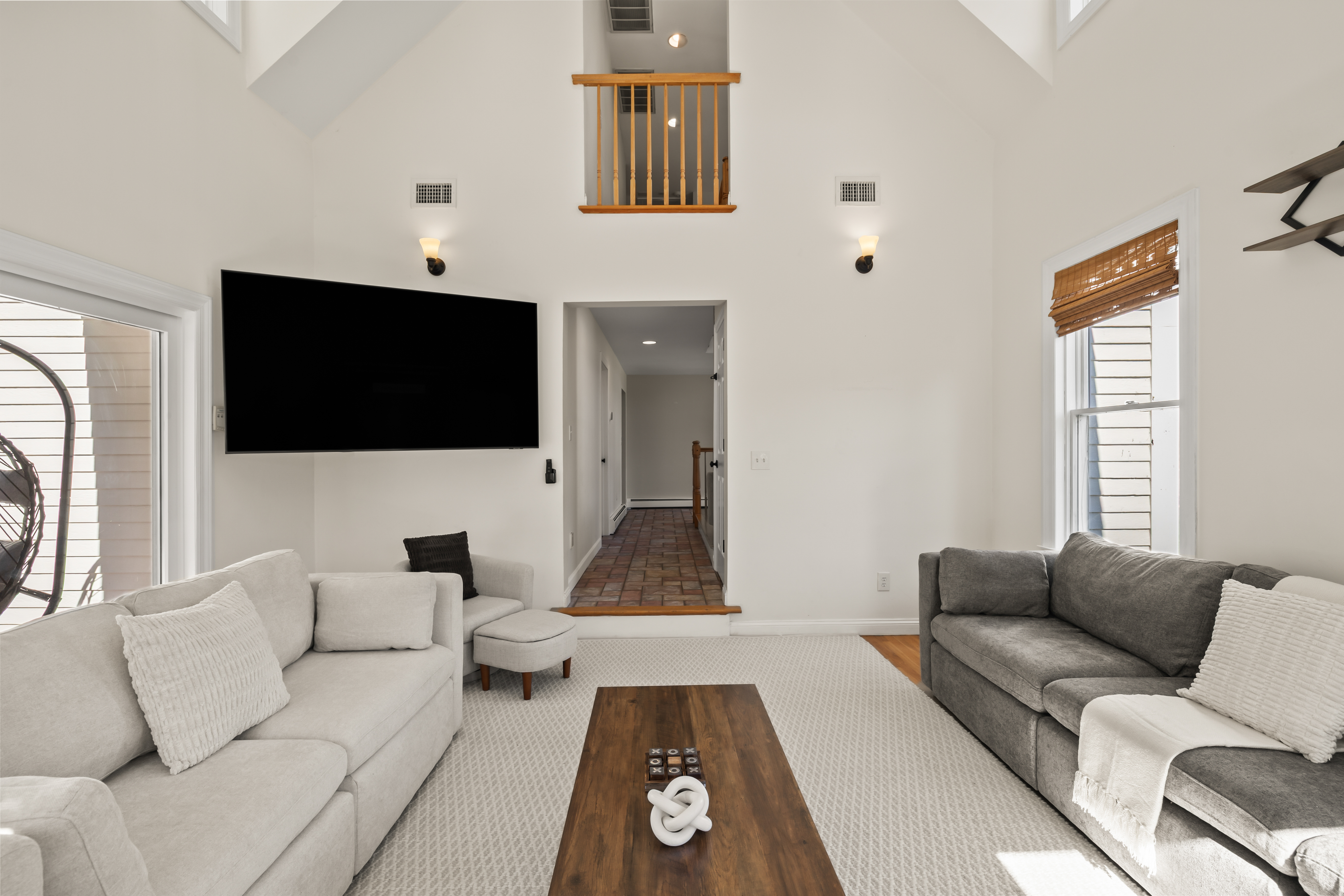 Bright vaulted living room with large TV and comfortable lounge seating