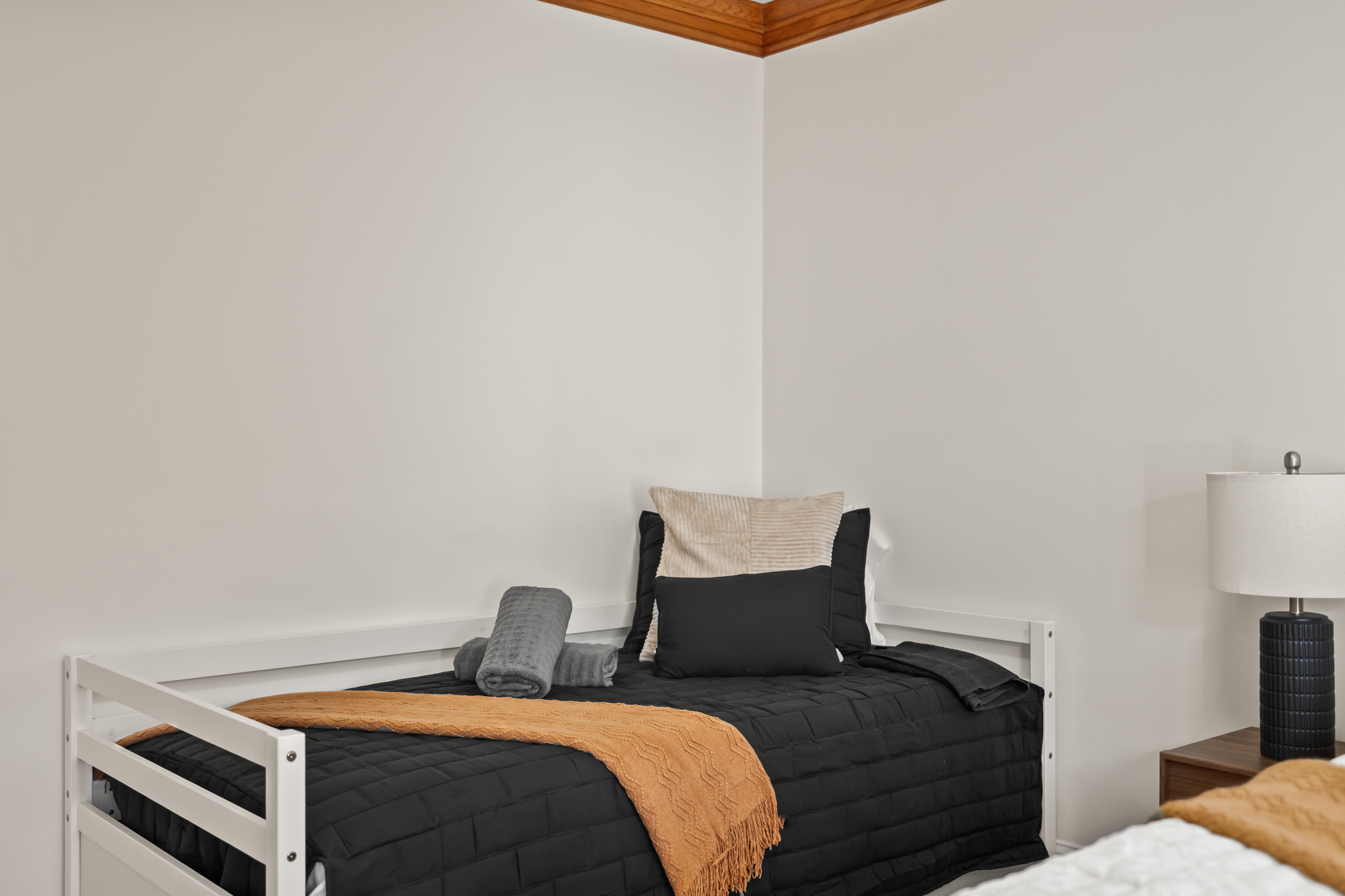Bright minimalist bedroom with cozy accents and modern bedside styling