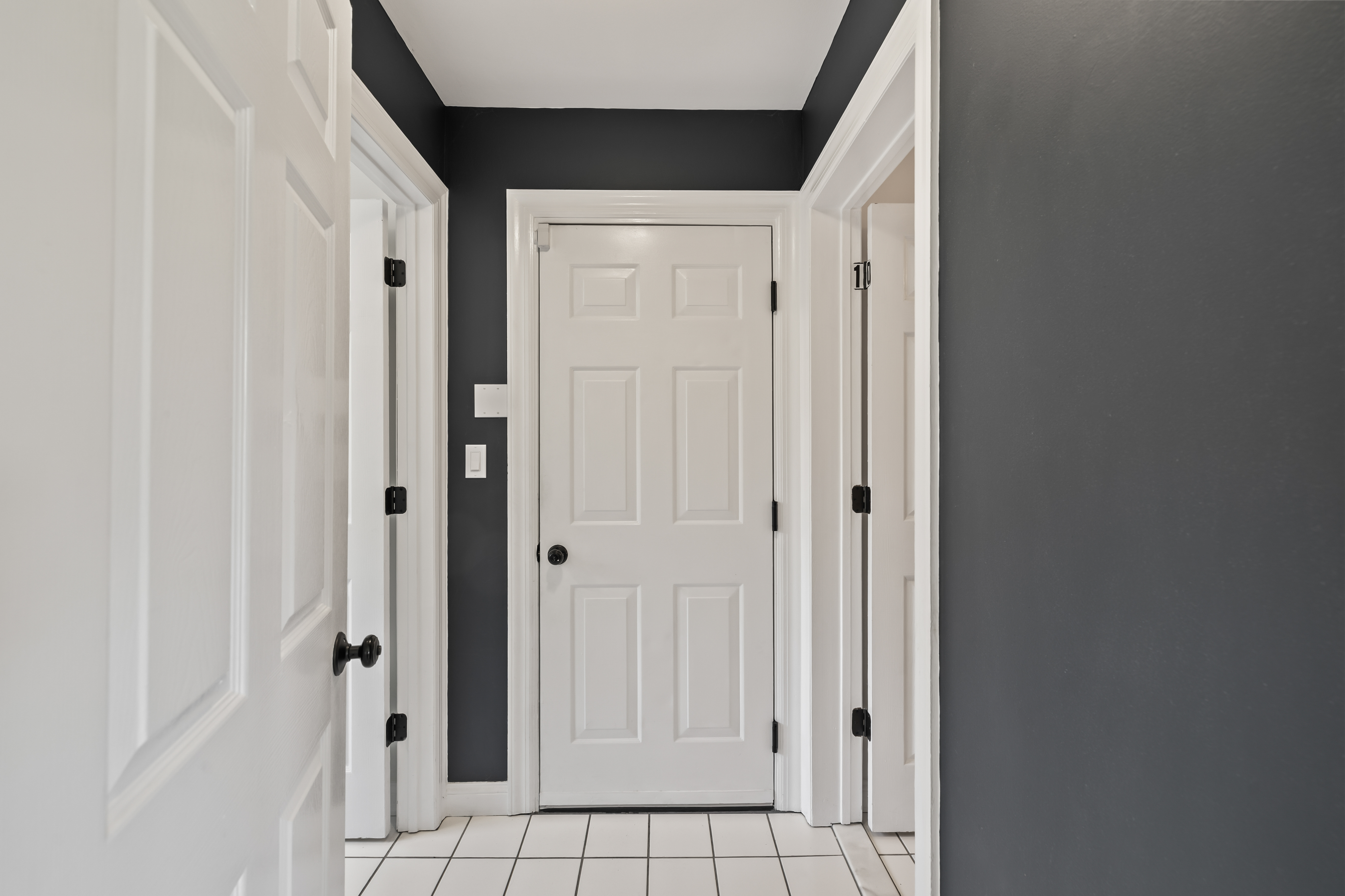 Clean modern hallway with bold accents and easy-care tile flooring