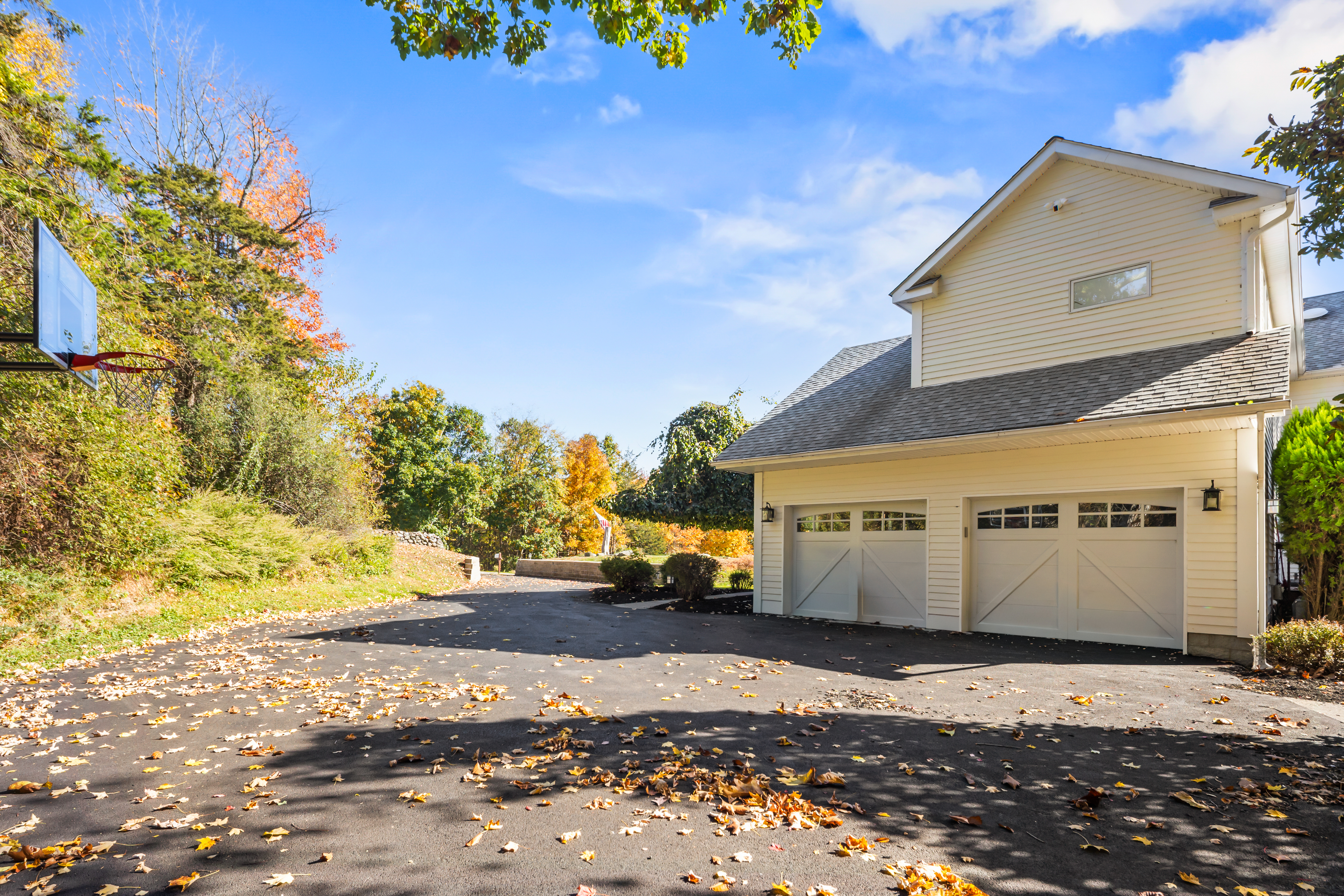 Spacious driveway and 3-car garage in a peaceful, tree-lined setting