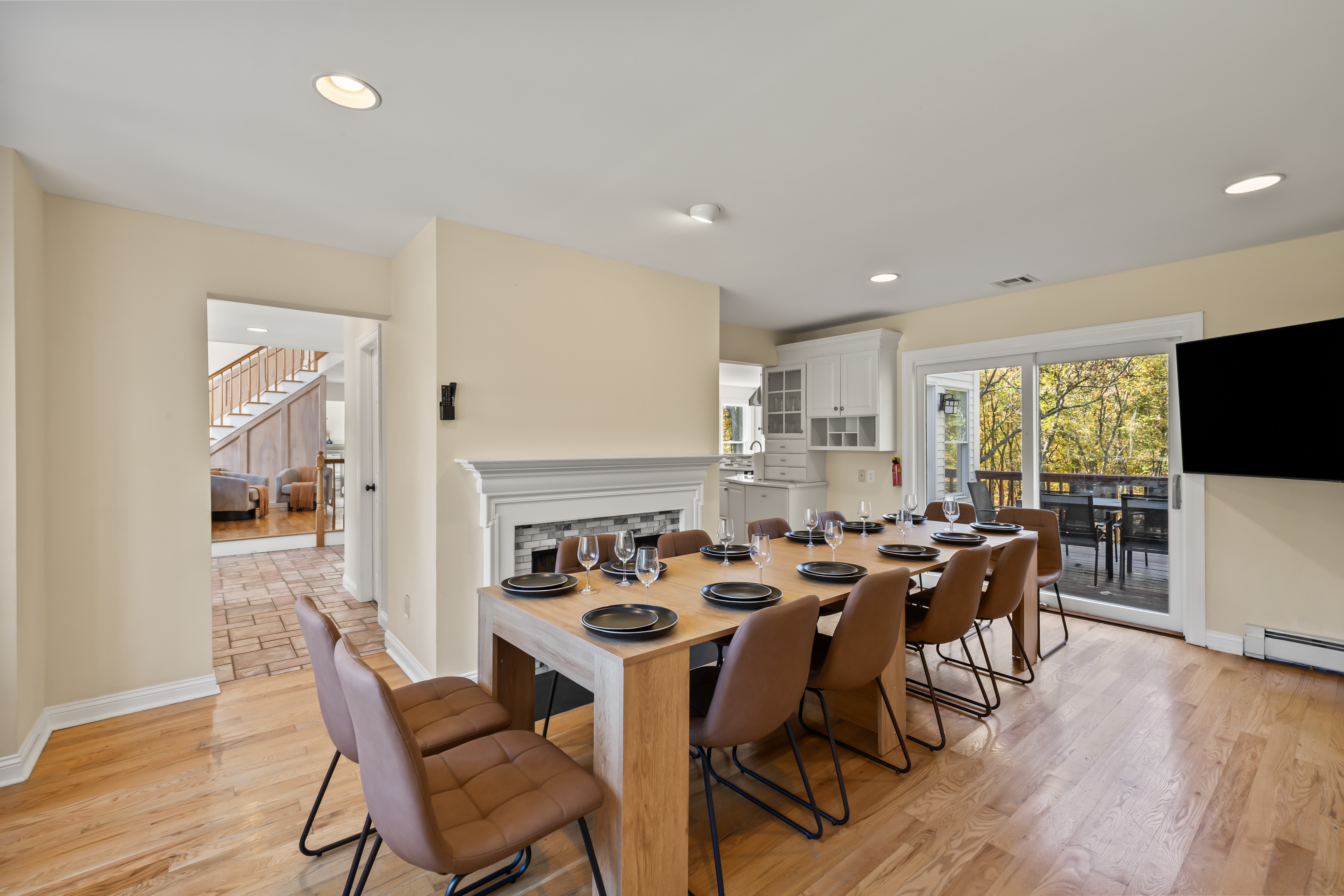 Spacious dining for 10 with deck access, fireplace, and bright open layout