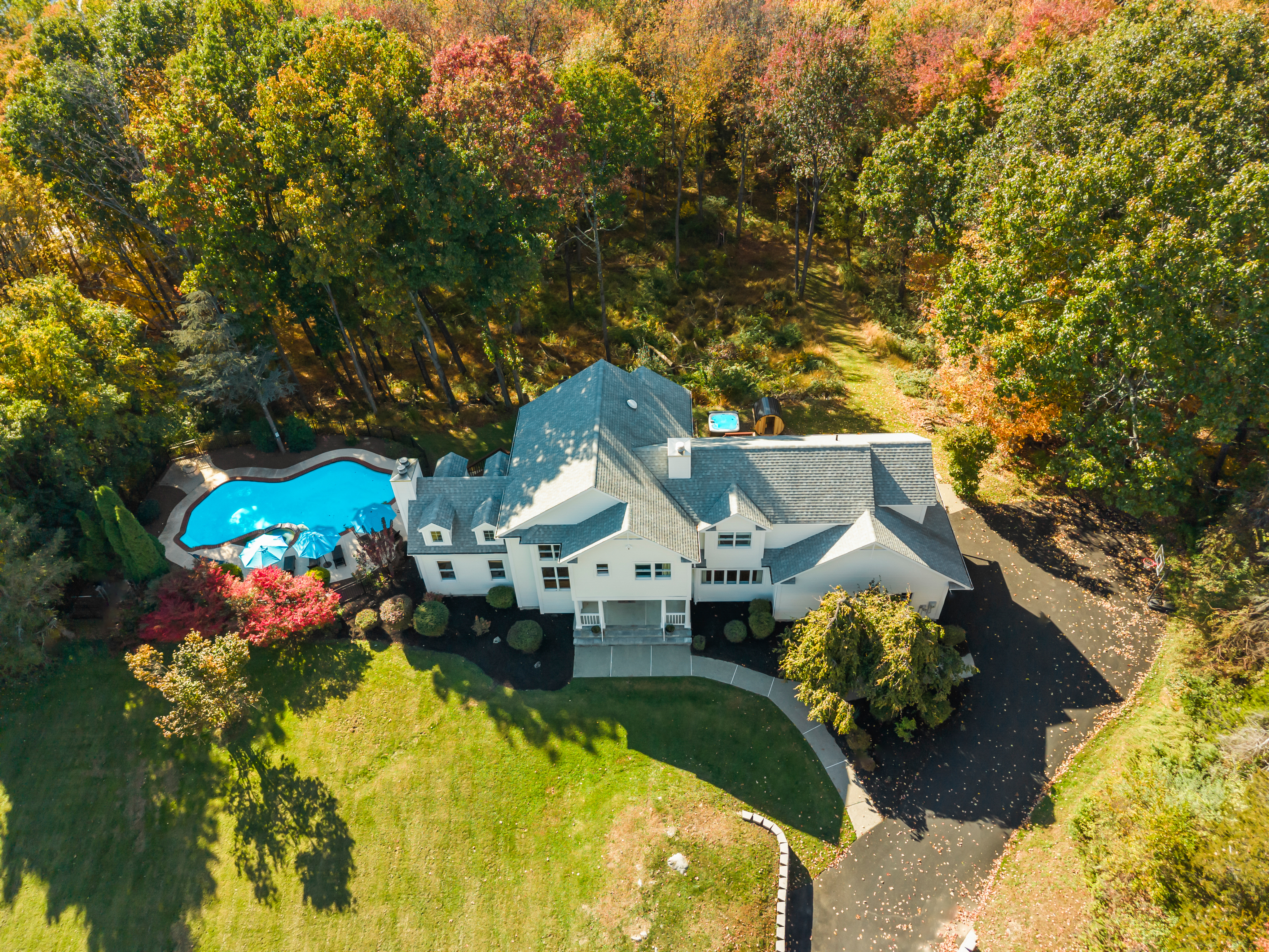 Private estate with pool, expansive lawn, and stunning fall woodland setting