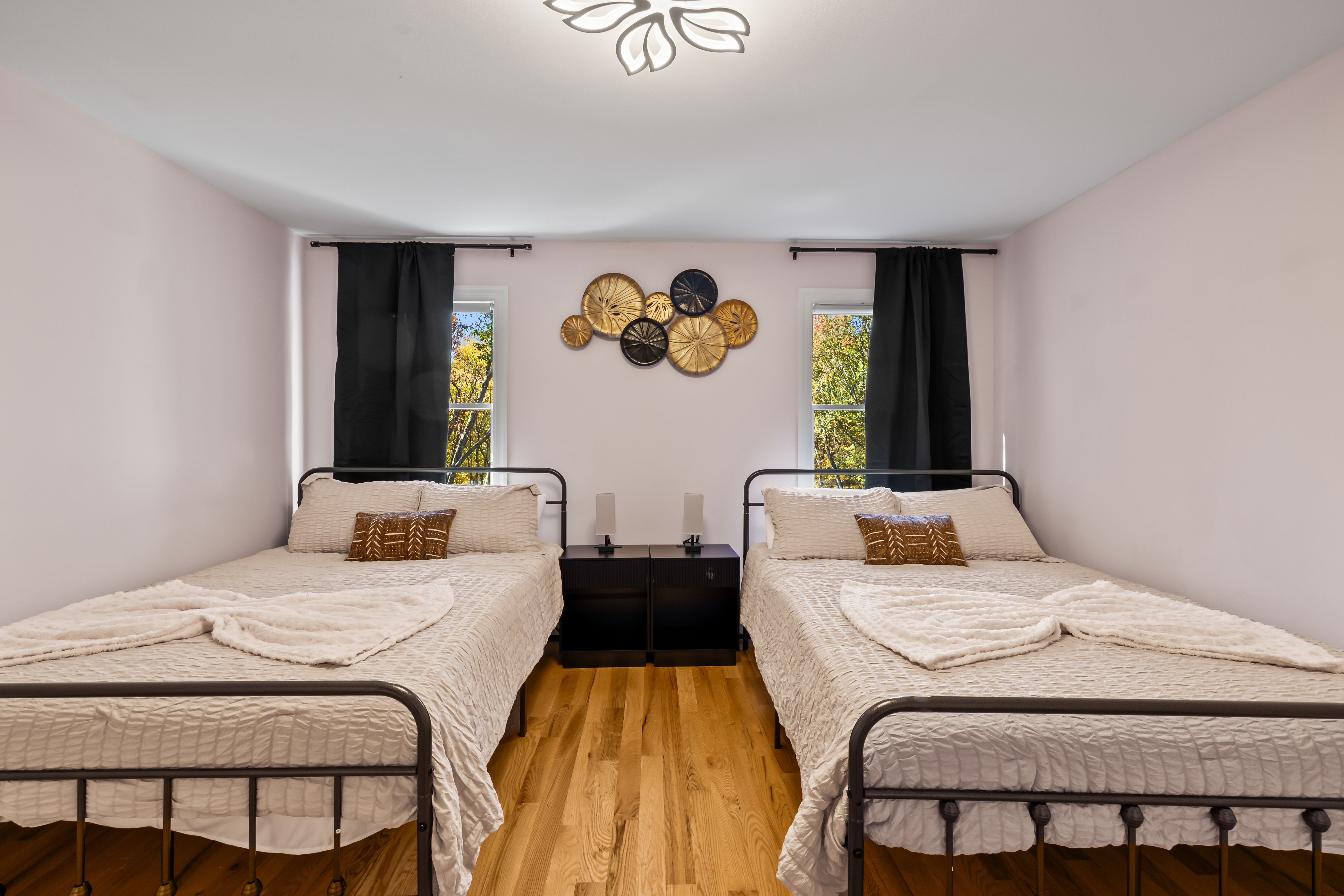 Bright double bedroom with two cozy beds and stylish modern accents