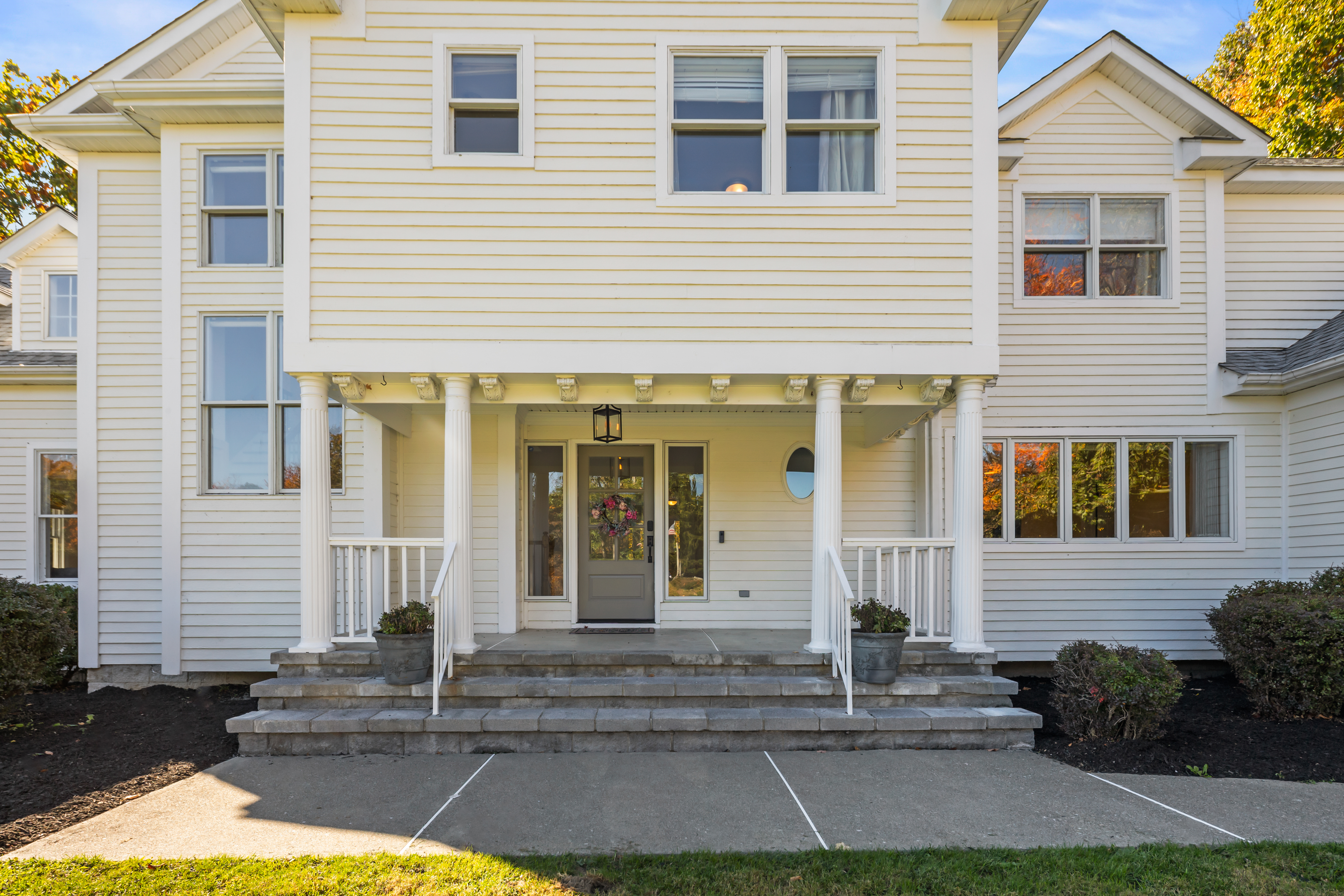 Grand front entry with covered porch and classic curb appeal