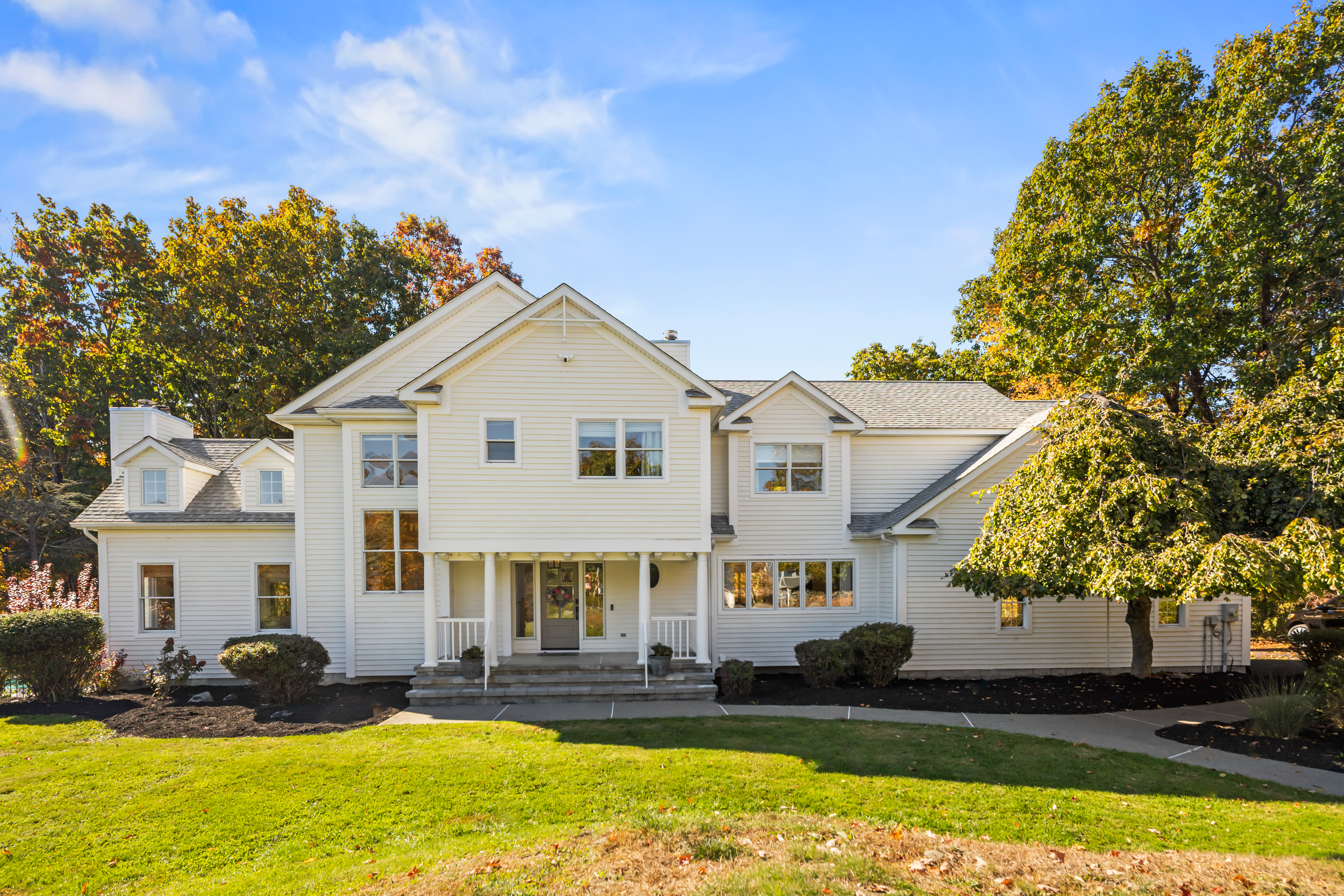 Spacious, elegant home with beautiful curb appeal and lush mature trees
