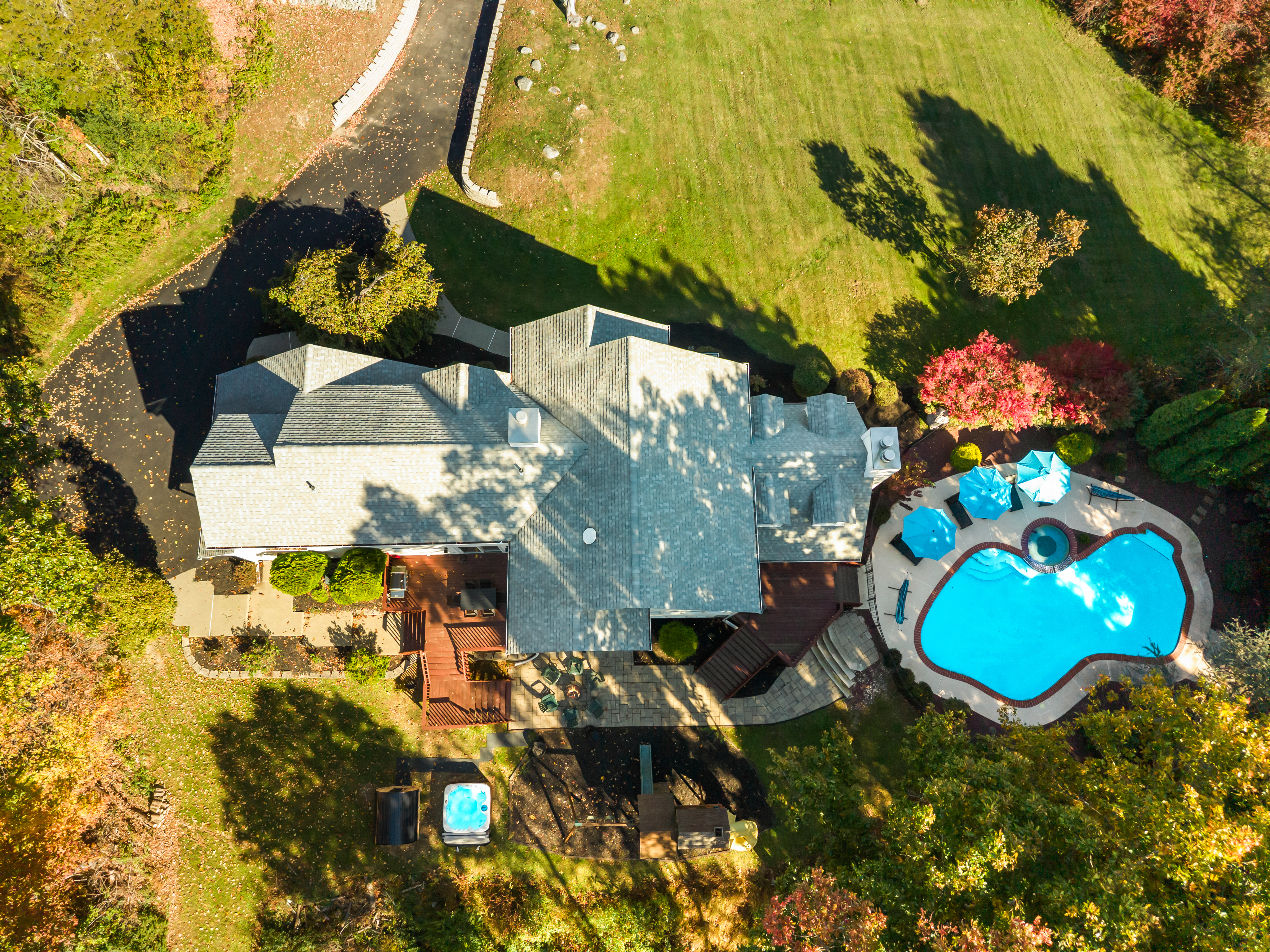 Aerial view of private estate with pool, hot tub, and expansive grounds