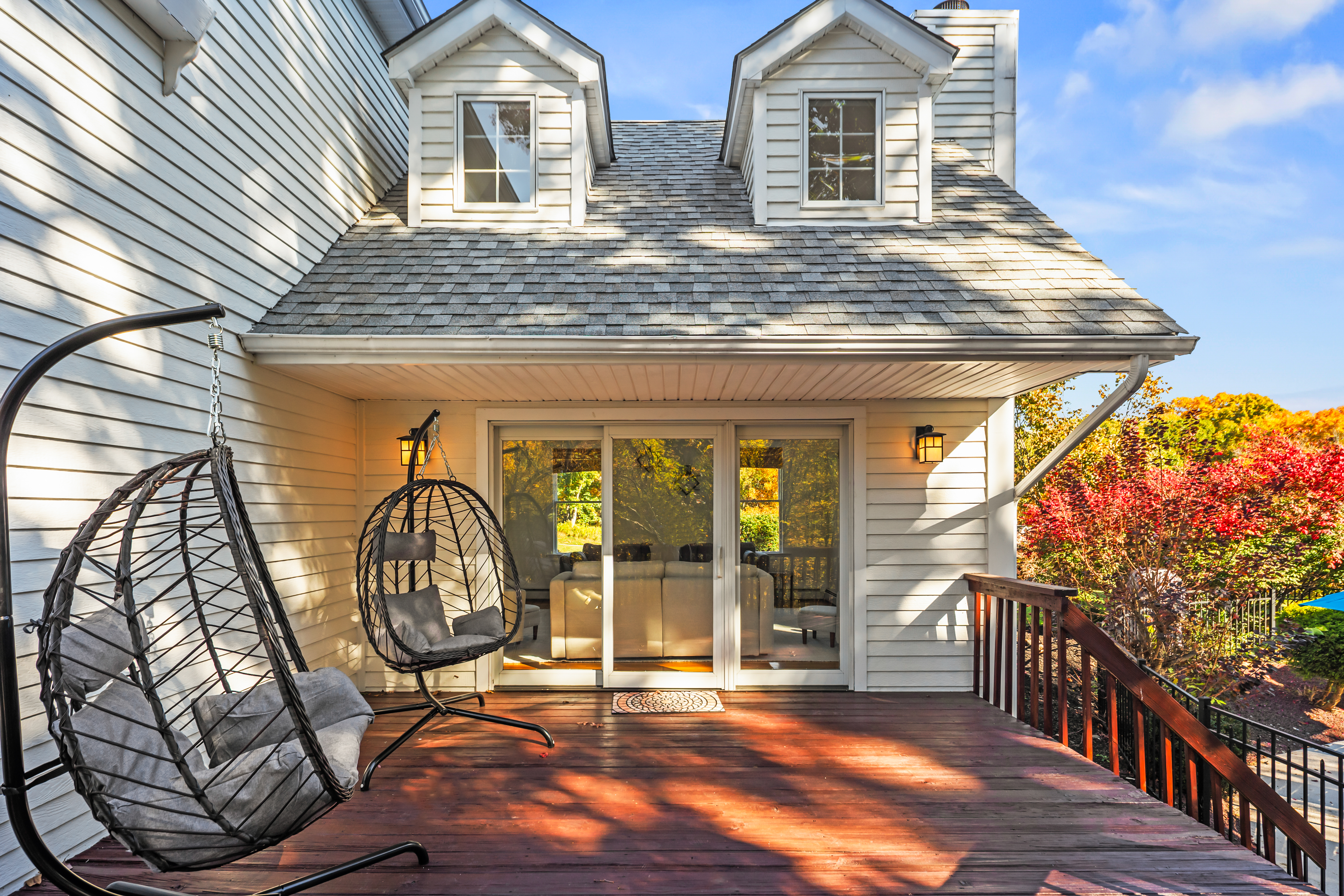 Private deck with hanging egg chairs and colorful seasonal views
