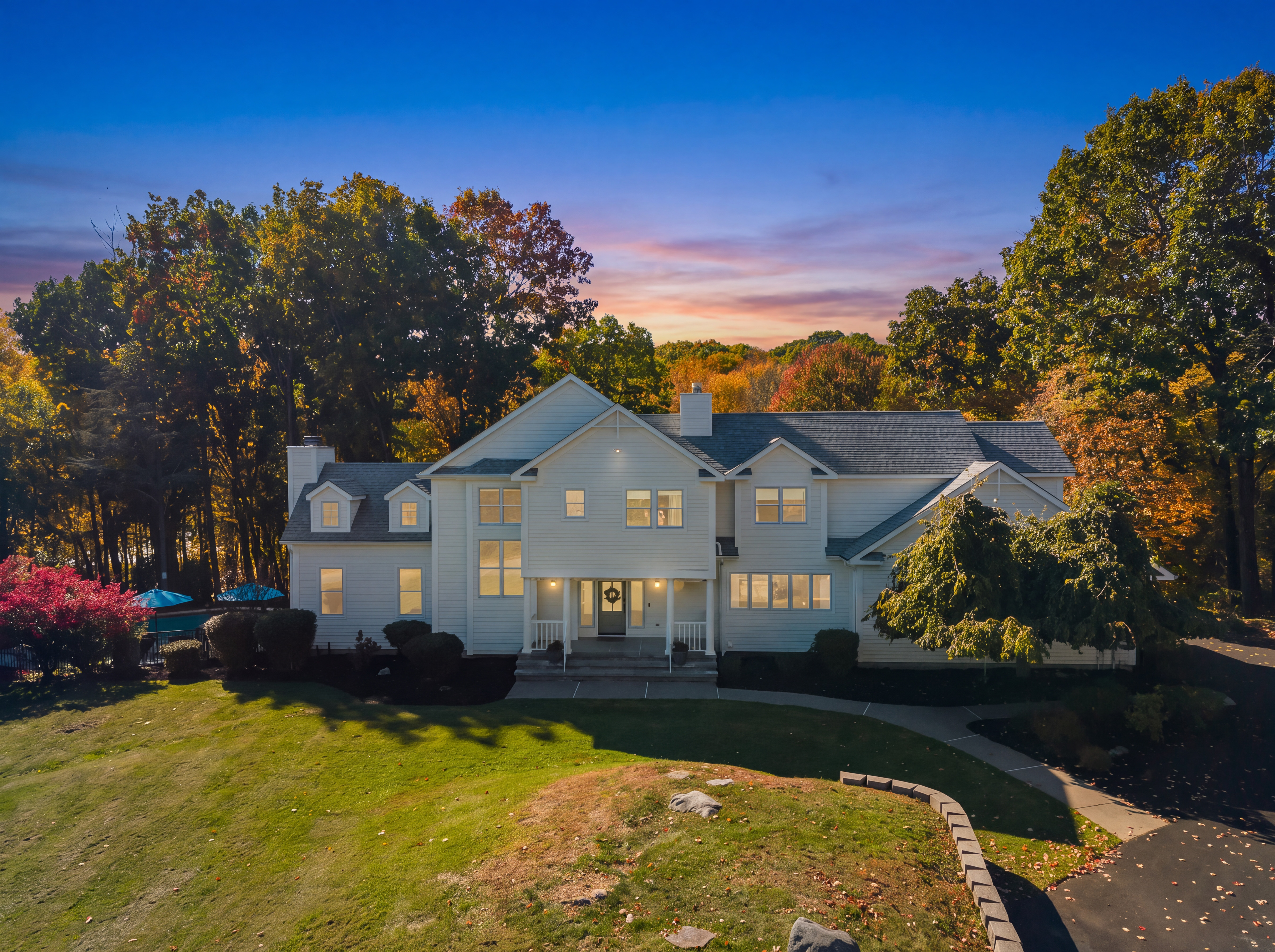 Elegant estate with spacious lawn and stunning sunset views
