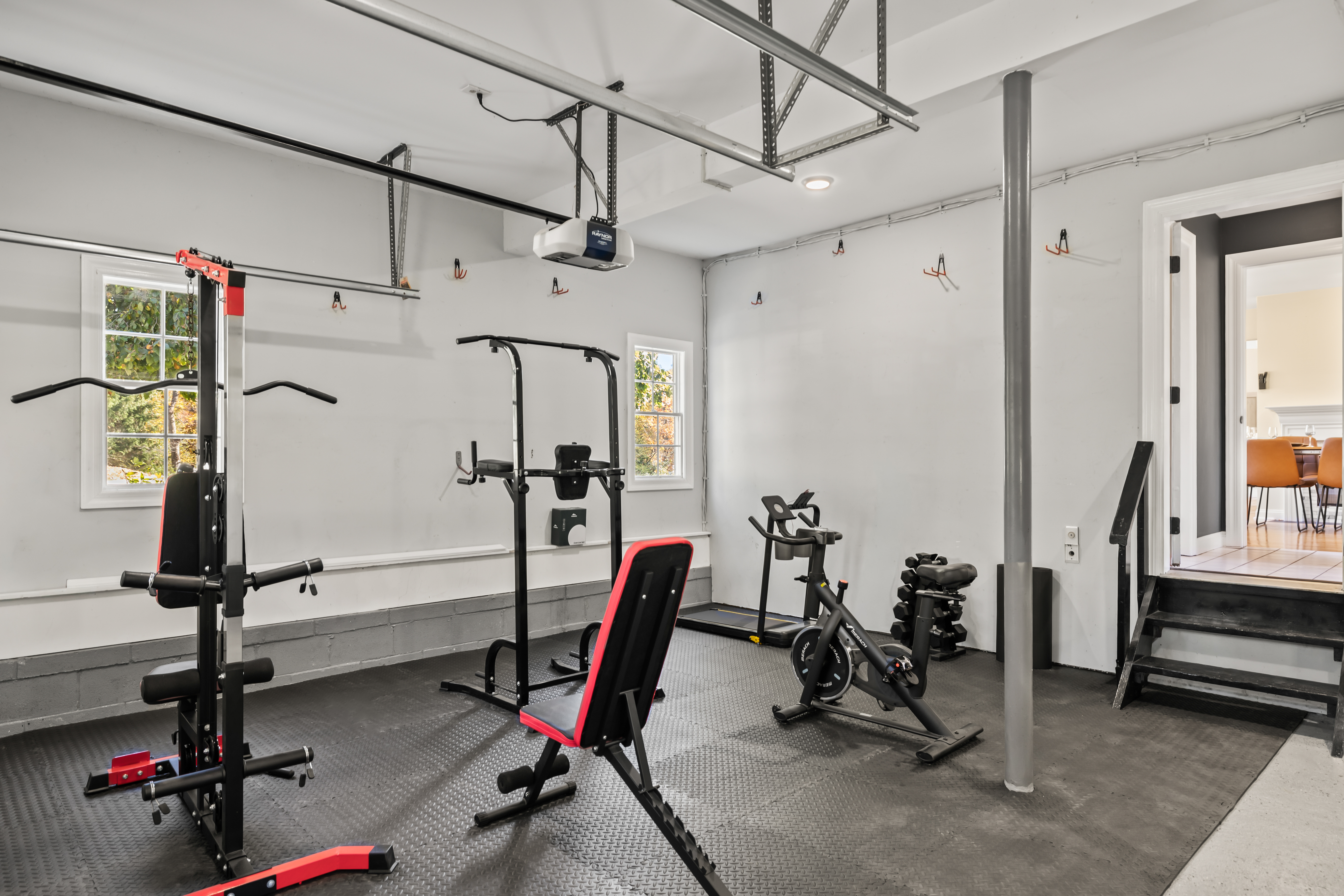 Private garage gym with bike, weights, and strength equipment