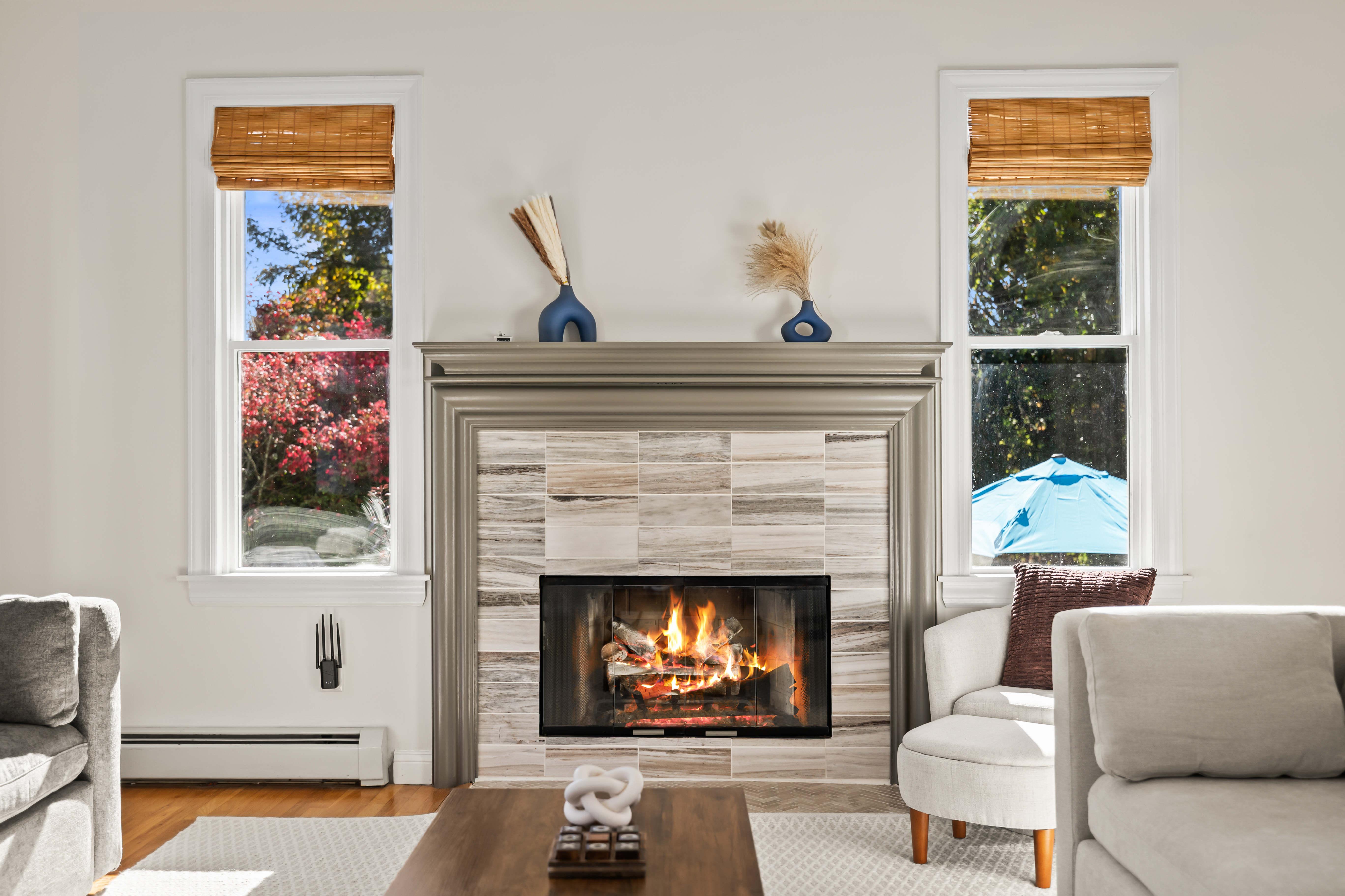 Bright living room with cozy fireplace and sun-filled garden views