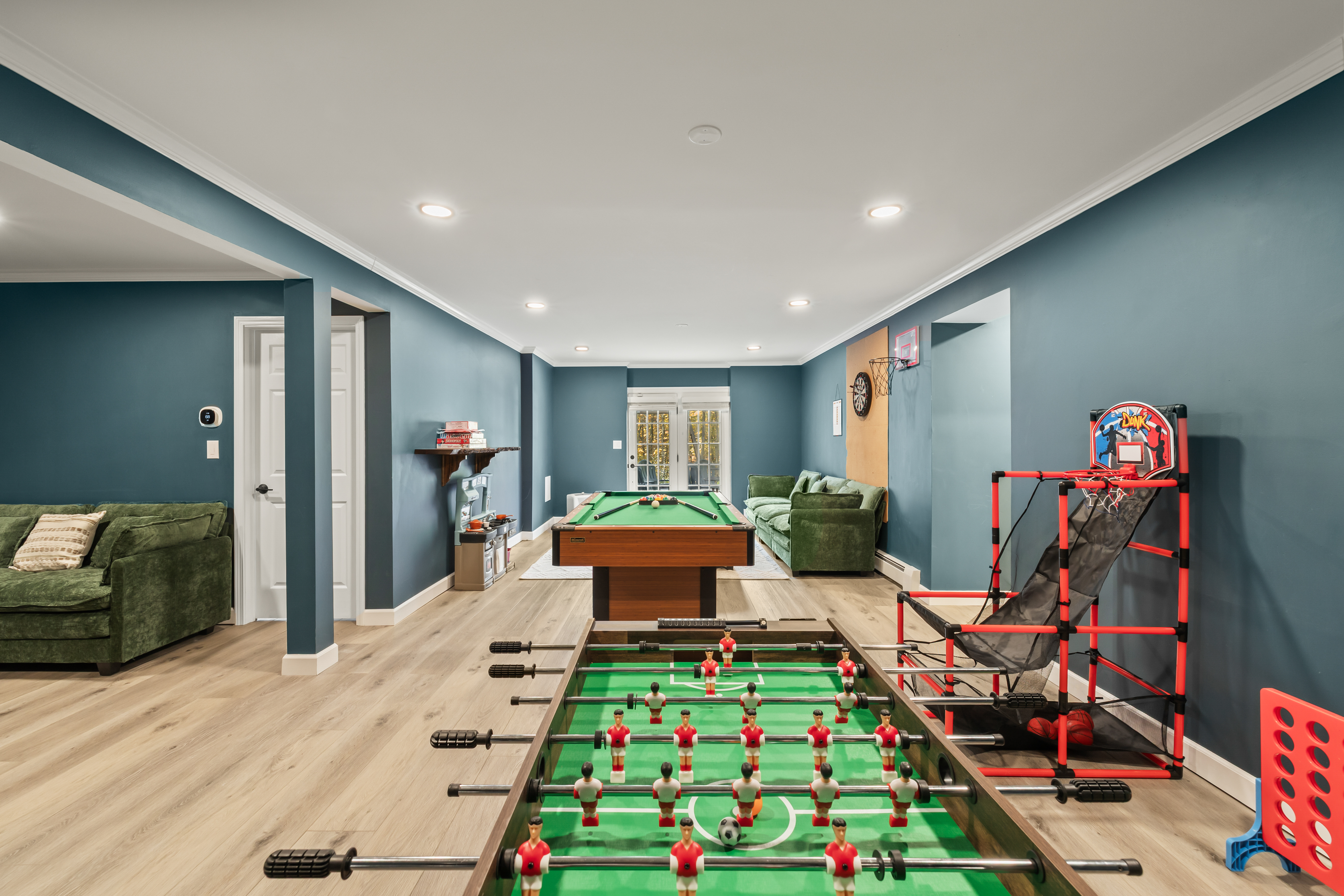 Spacious game room with foosball, pool table & arcade basketball