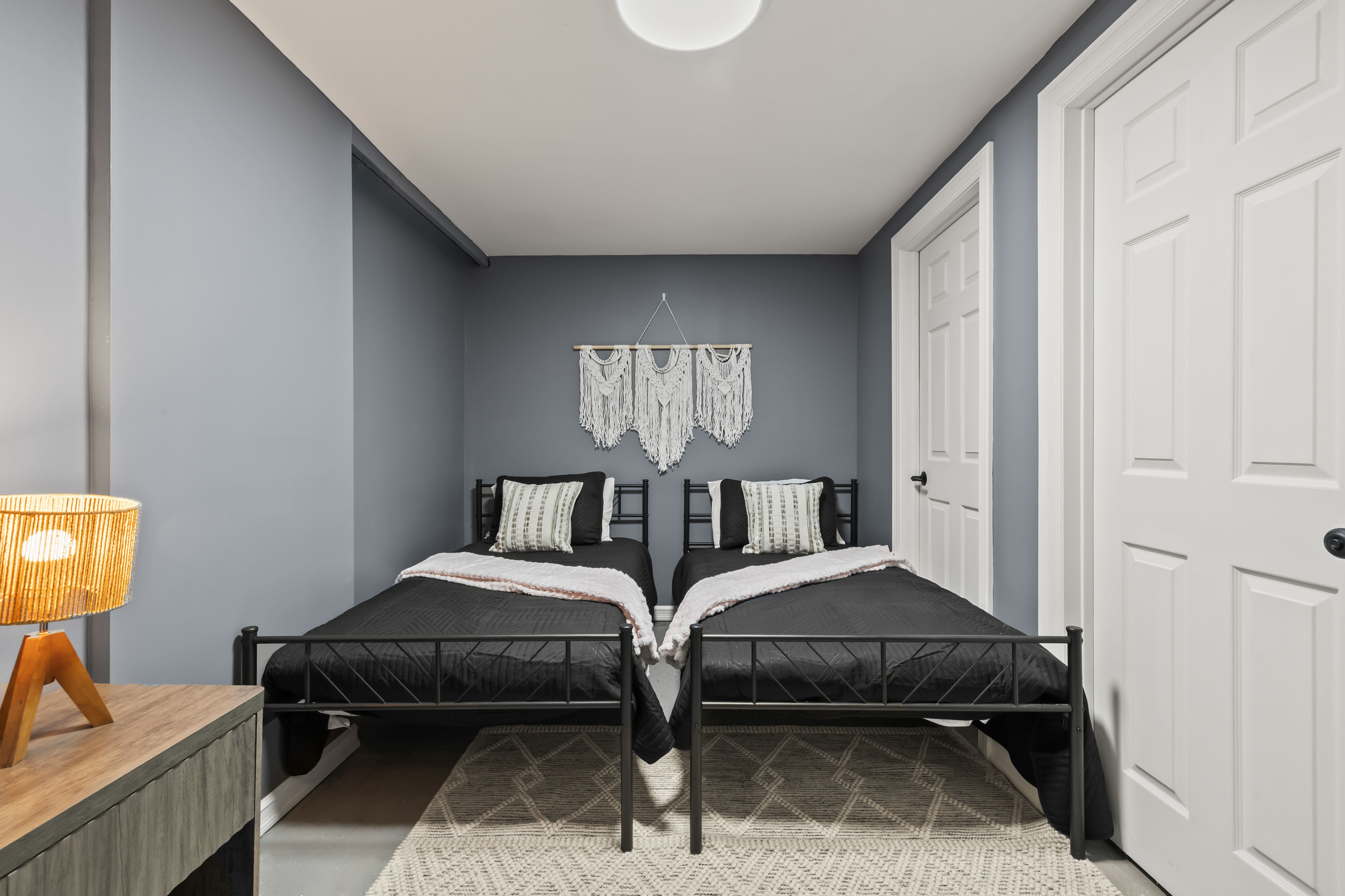 Cozy twin bedroom with modern decor and warm, inviting style