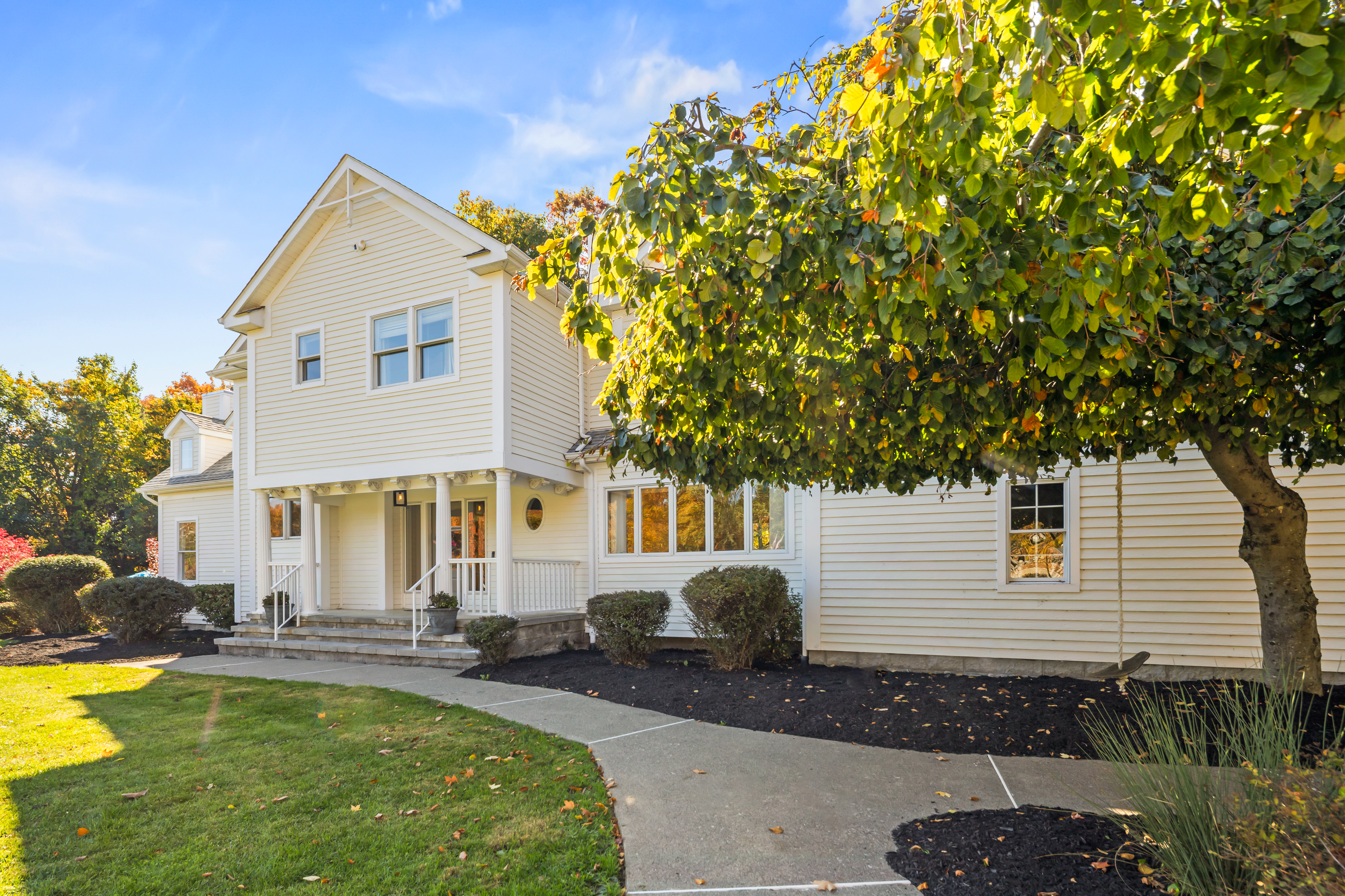 Welcoming exterior with lush landscaping and a bright, elegant entry
