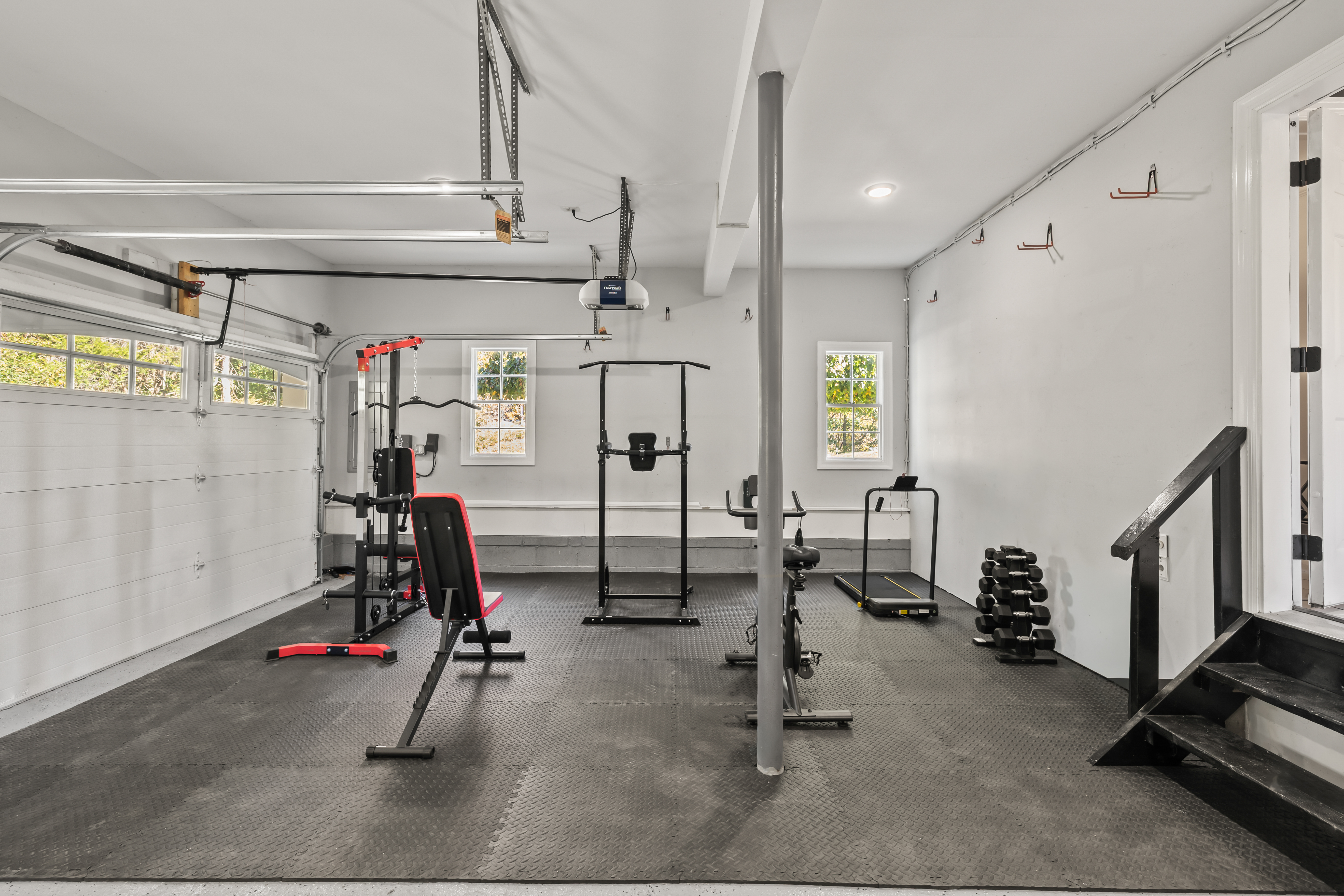 Private garage gym with weights, cardio equipment, and plenty of workout space