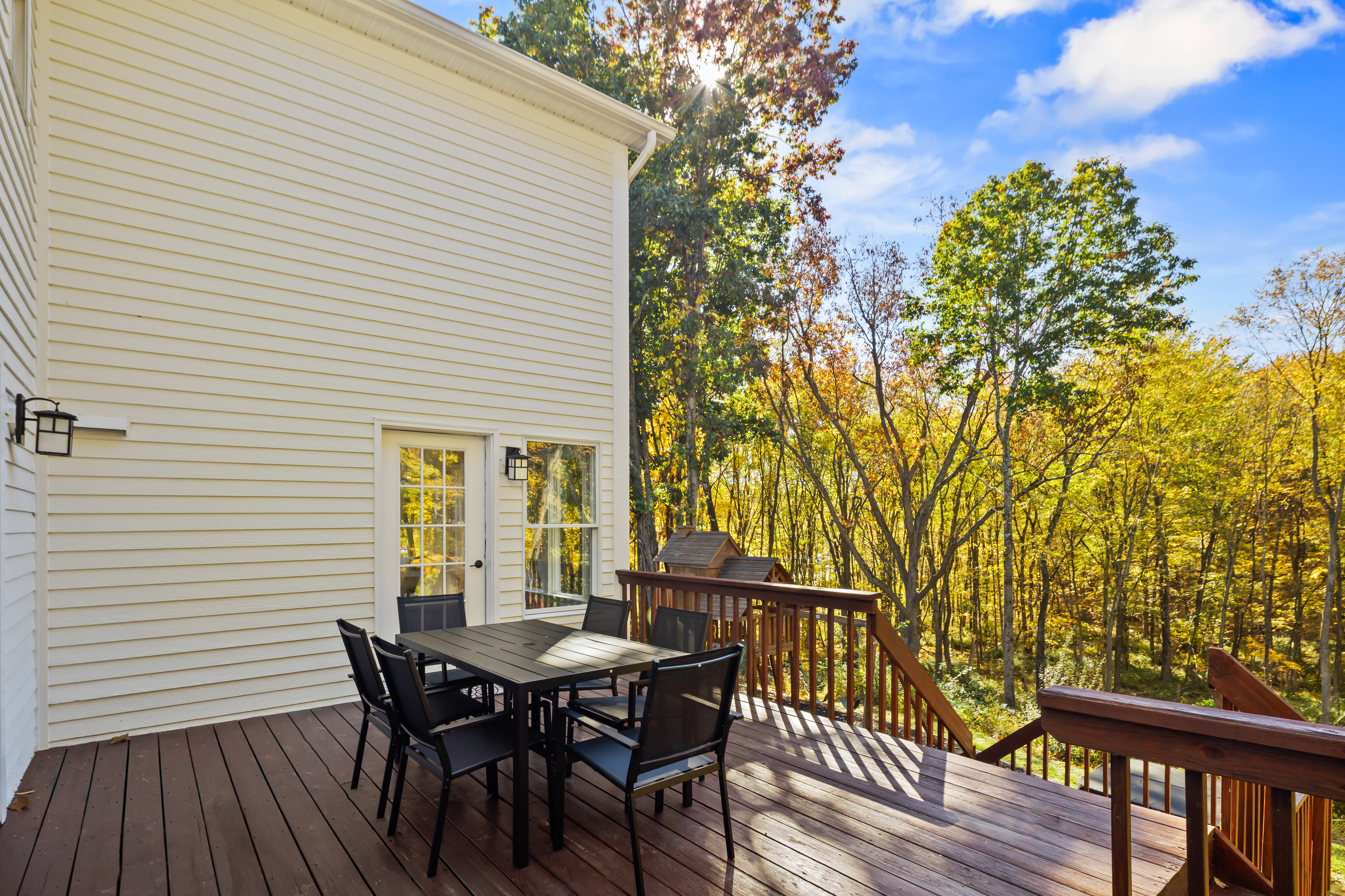 Private woodland deck with outdoor dining and scenic tree views
