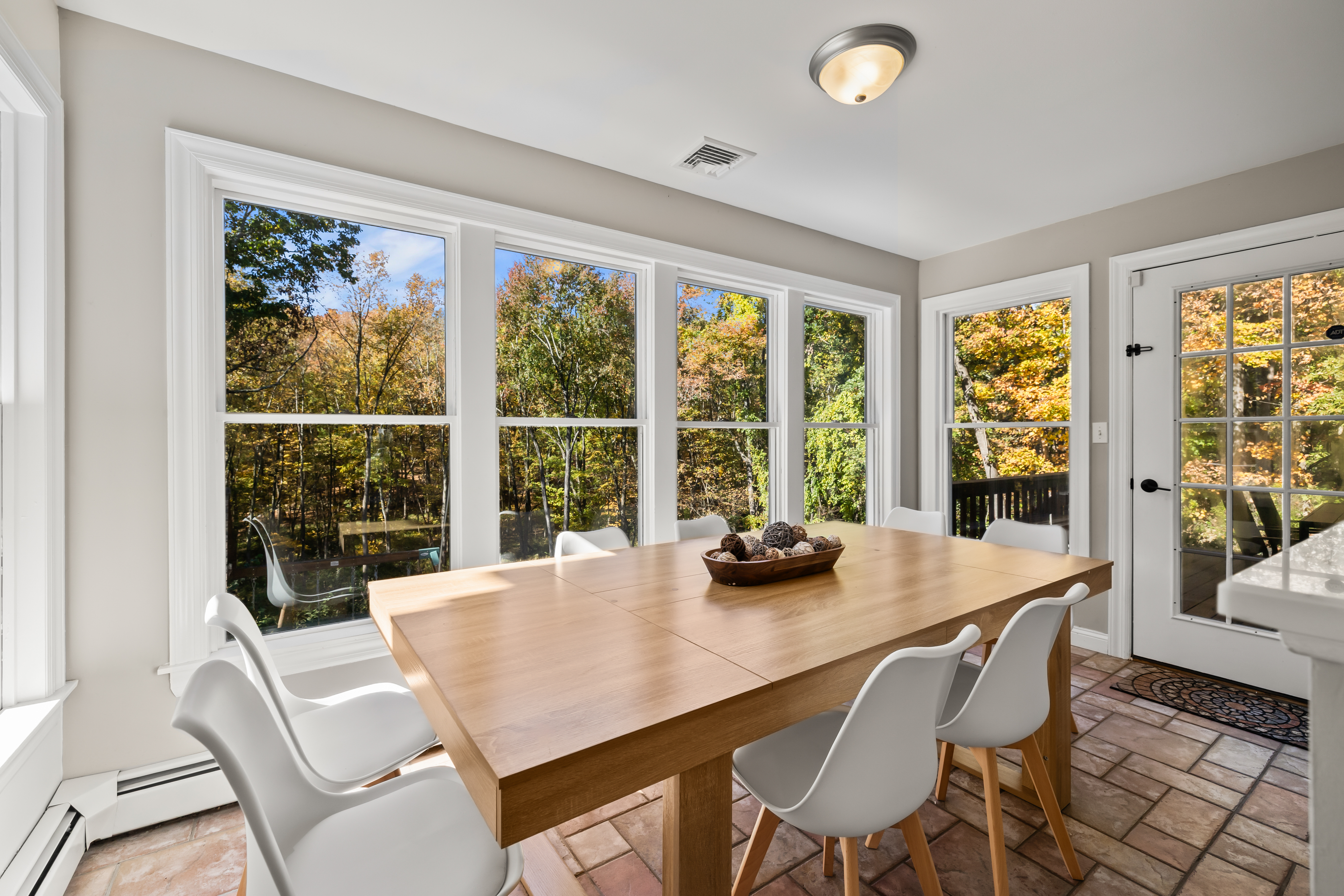 Sunny dining nook with forest views and direct access to the deck