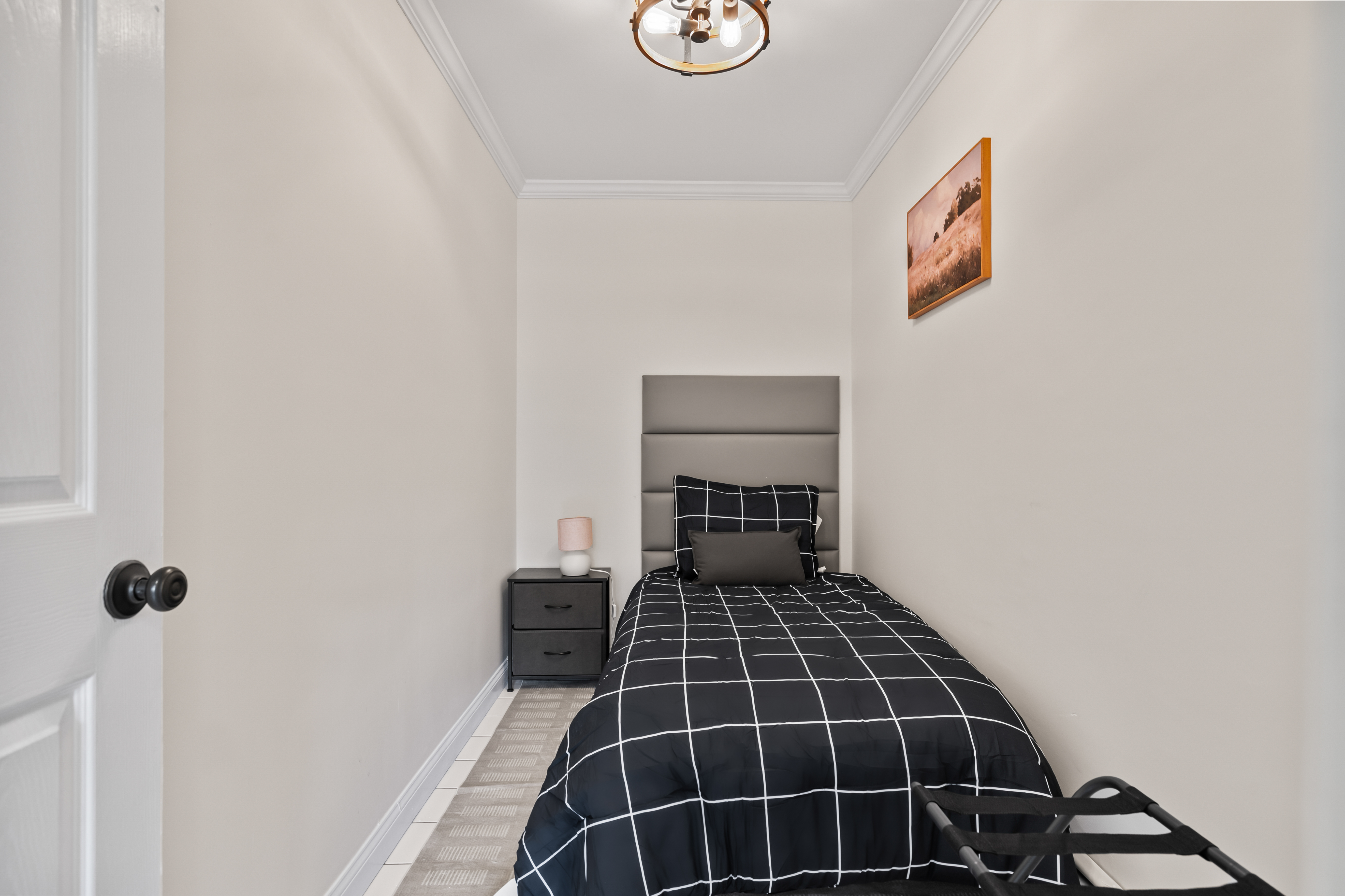 Cozy single bedroom with modern styling and convenient guest touches