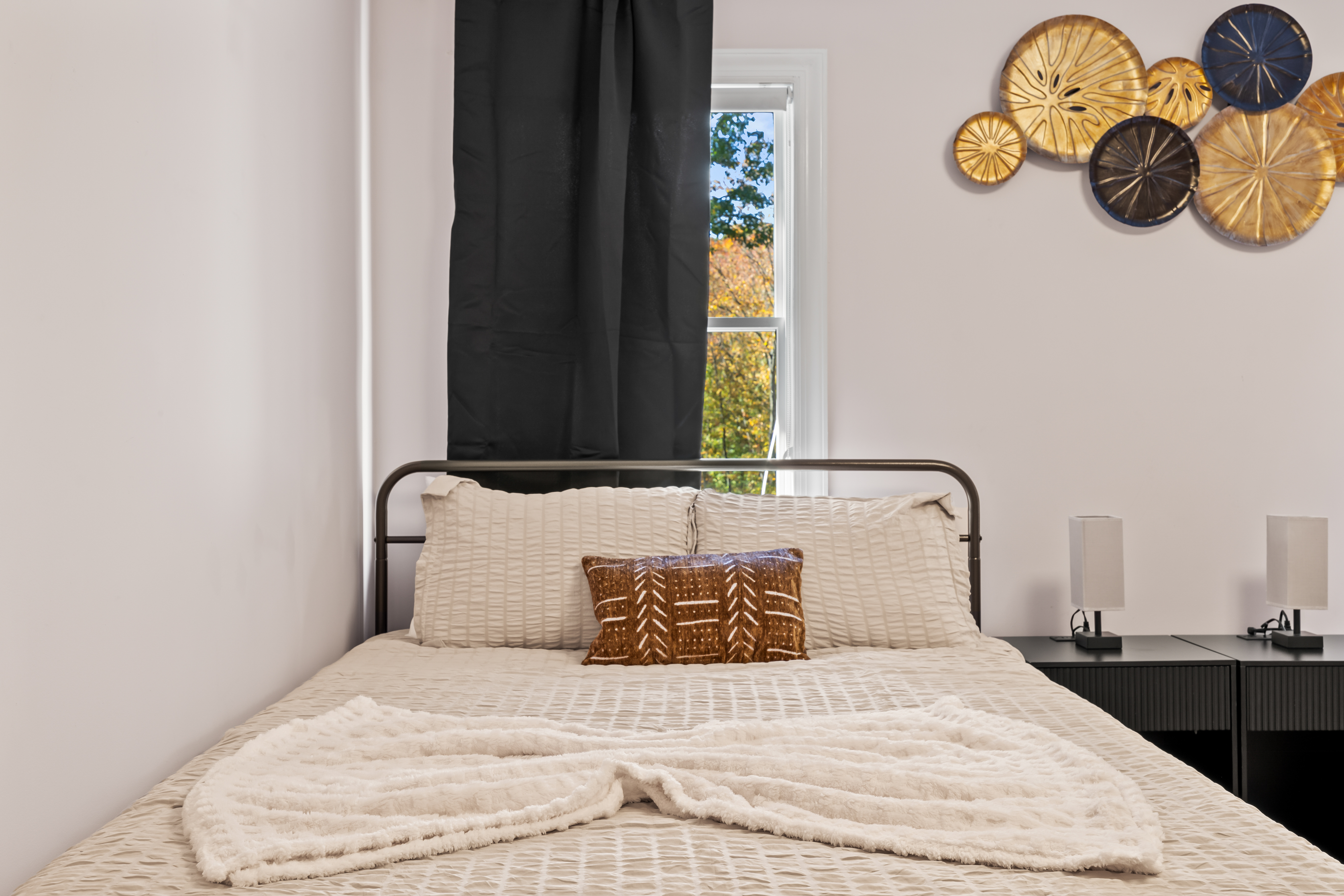 Cozy modern bedroom with natural light and stylish decor
