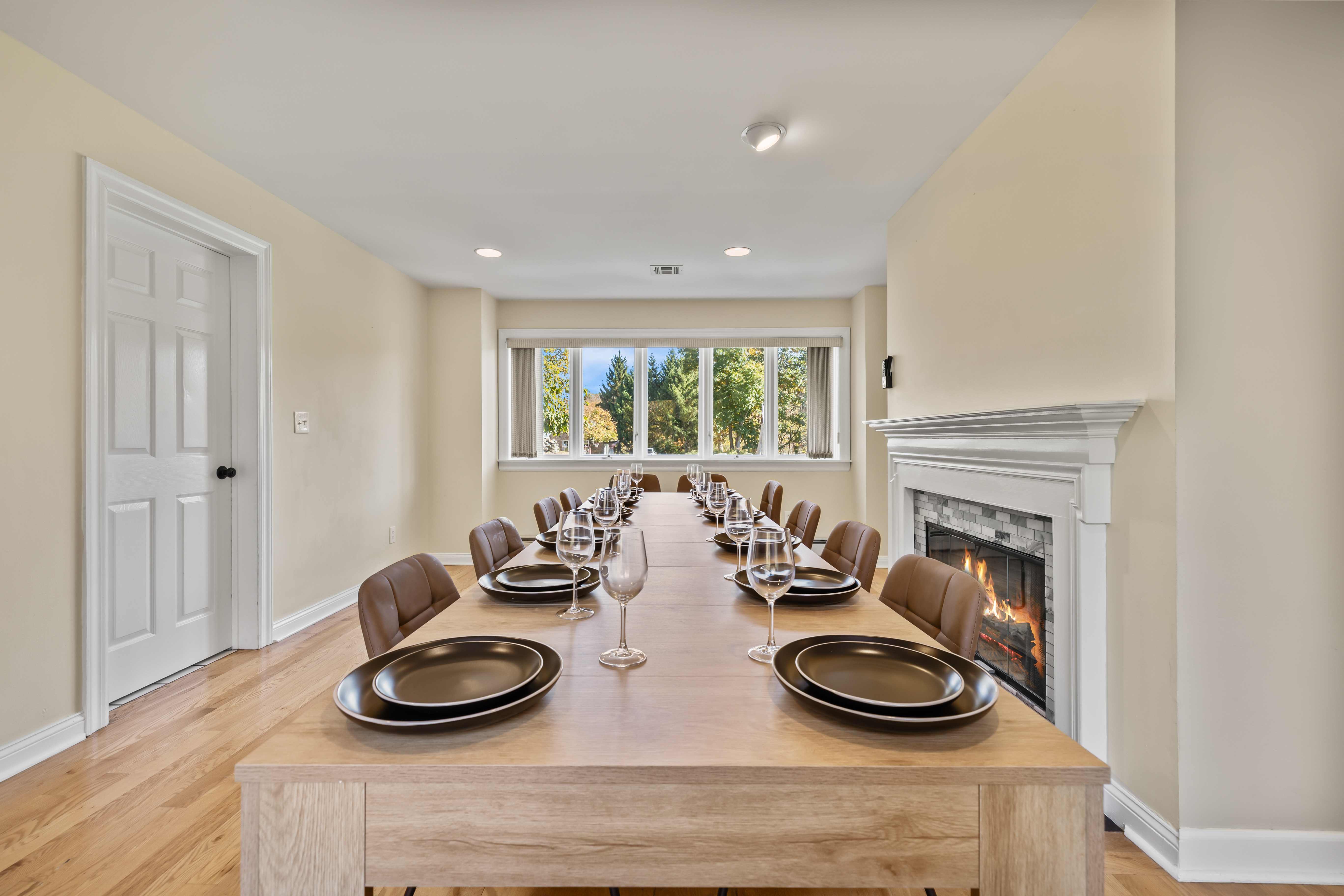 Spacious dining room with fireplace and large table for group gatherings