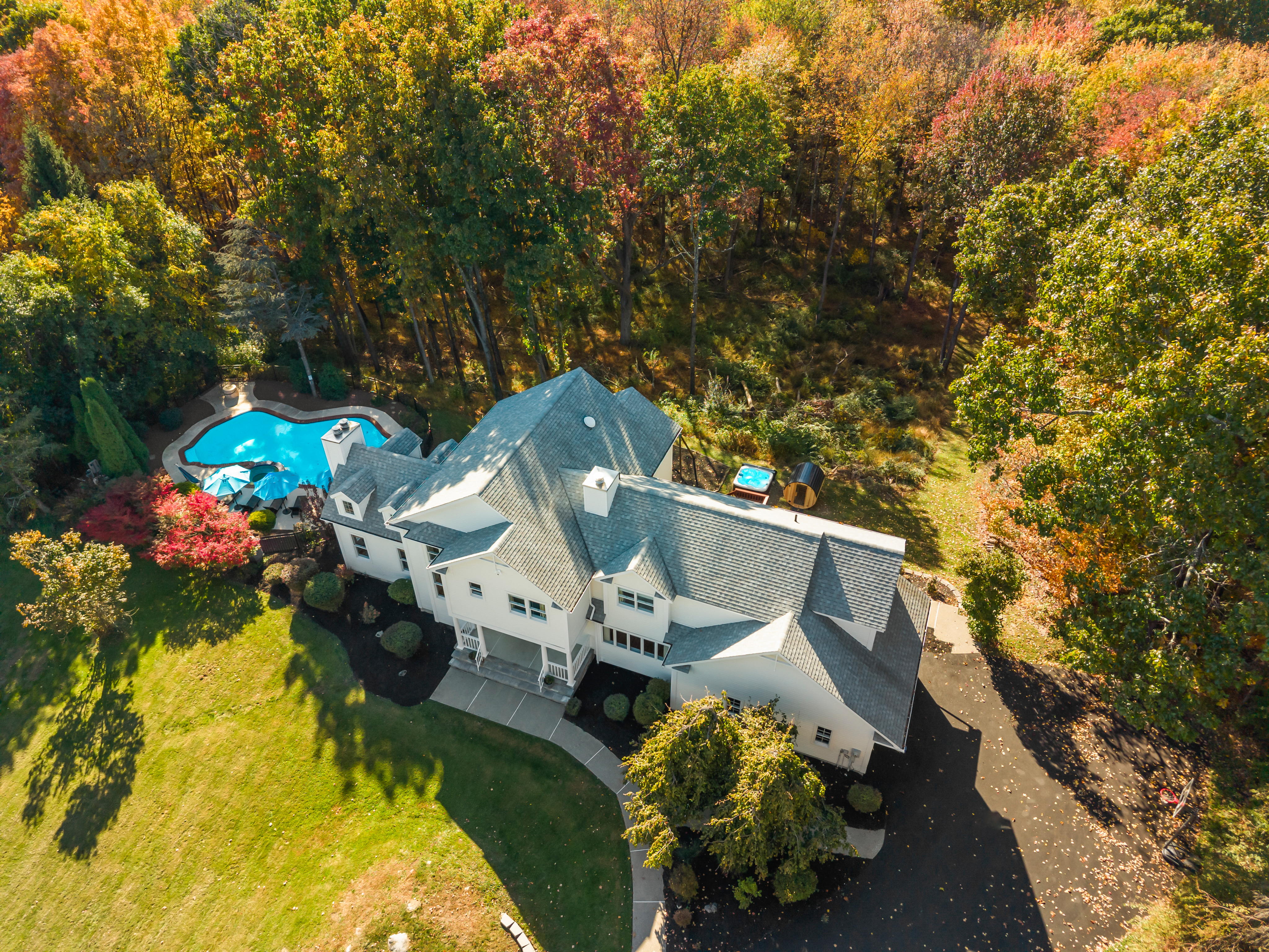 Private estate with pool, sweeping lawn, and stunning fall woodland views