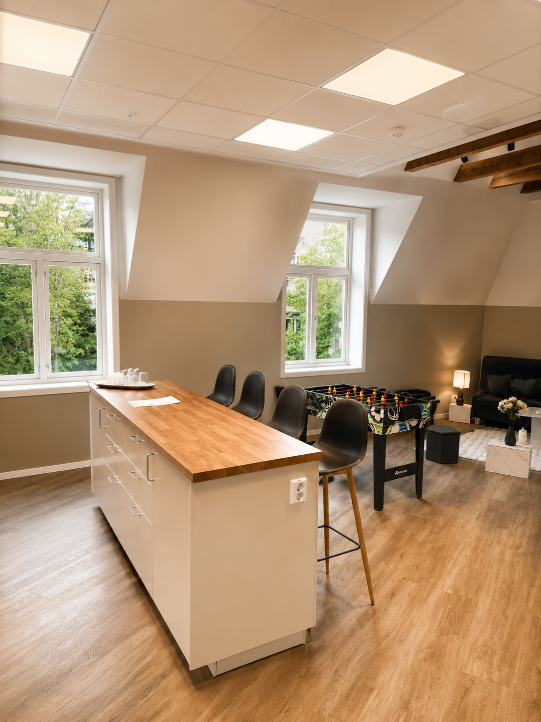 Bright social space with island seating, foosball, and cozy lounge area