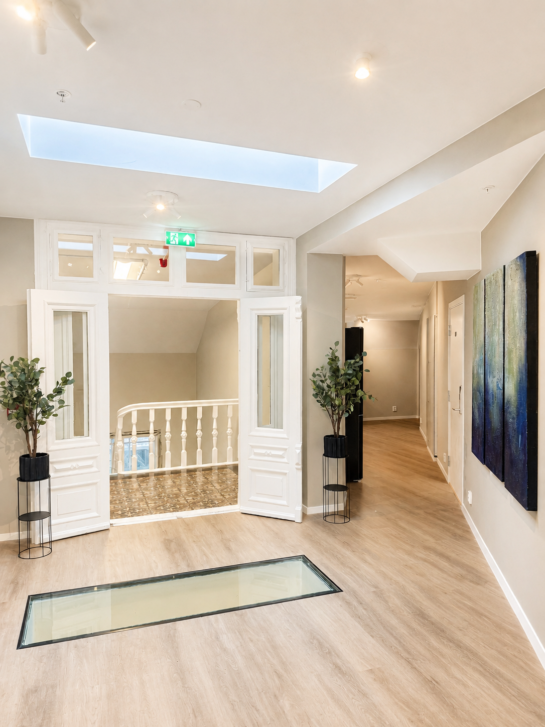 Bright, elegant hallway with skylight and charming architectural details