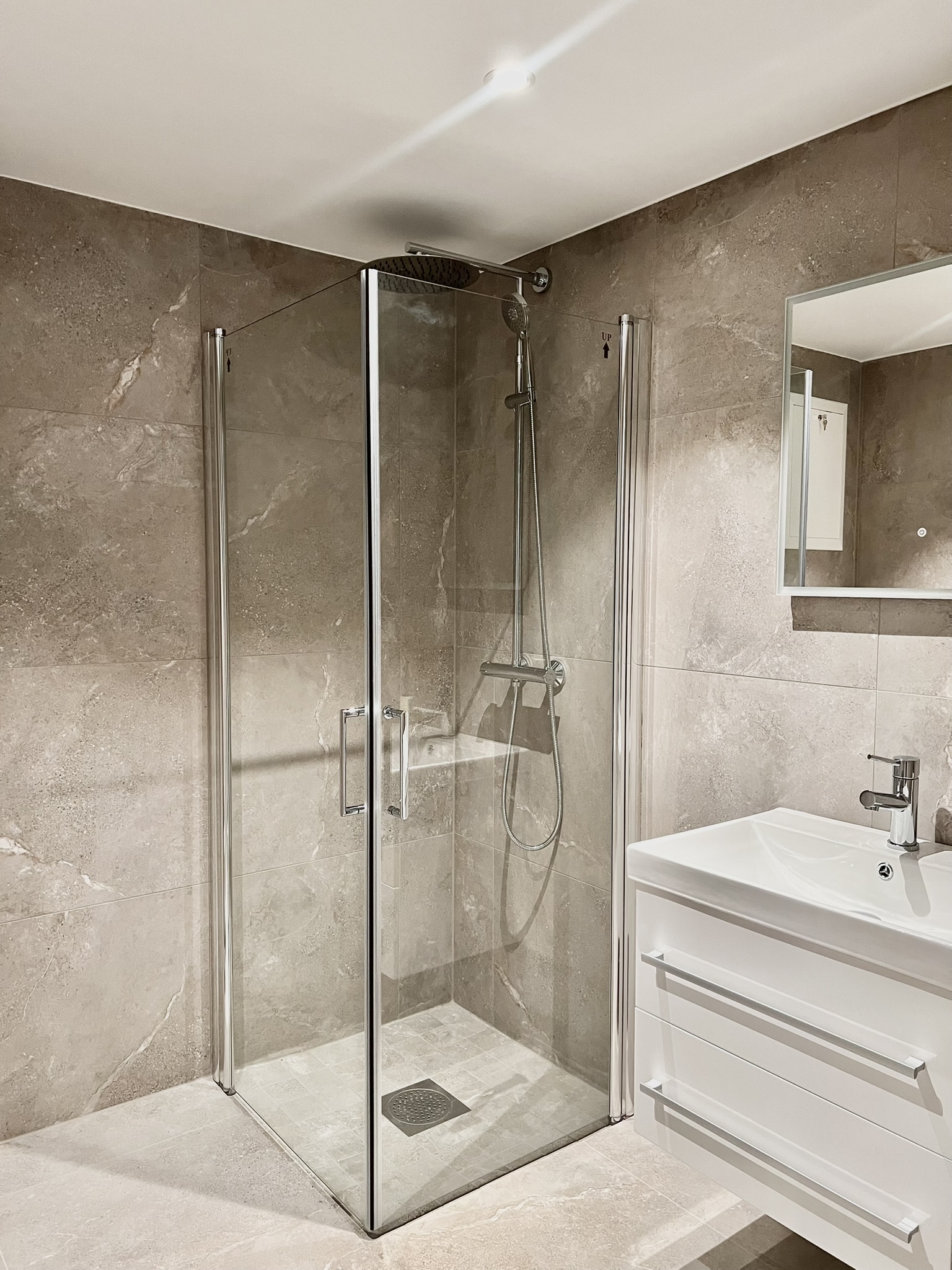 Modern tiled bathroom with sleek walk-in glass shower