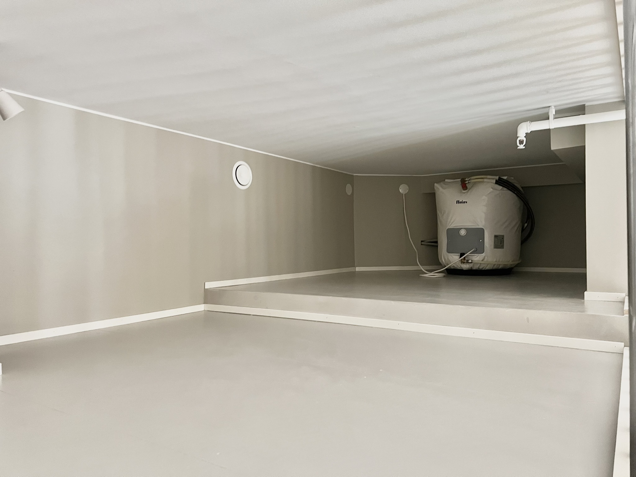 Clean utility/storage area with extra space for household essentials