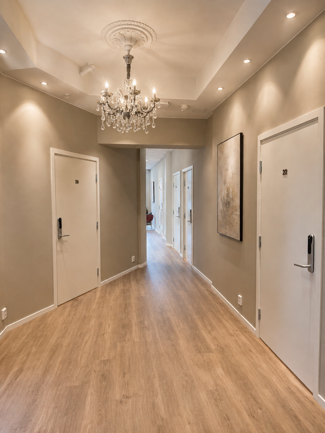 Elegant, well-lit hallway with chandelier and modern boutique-style design