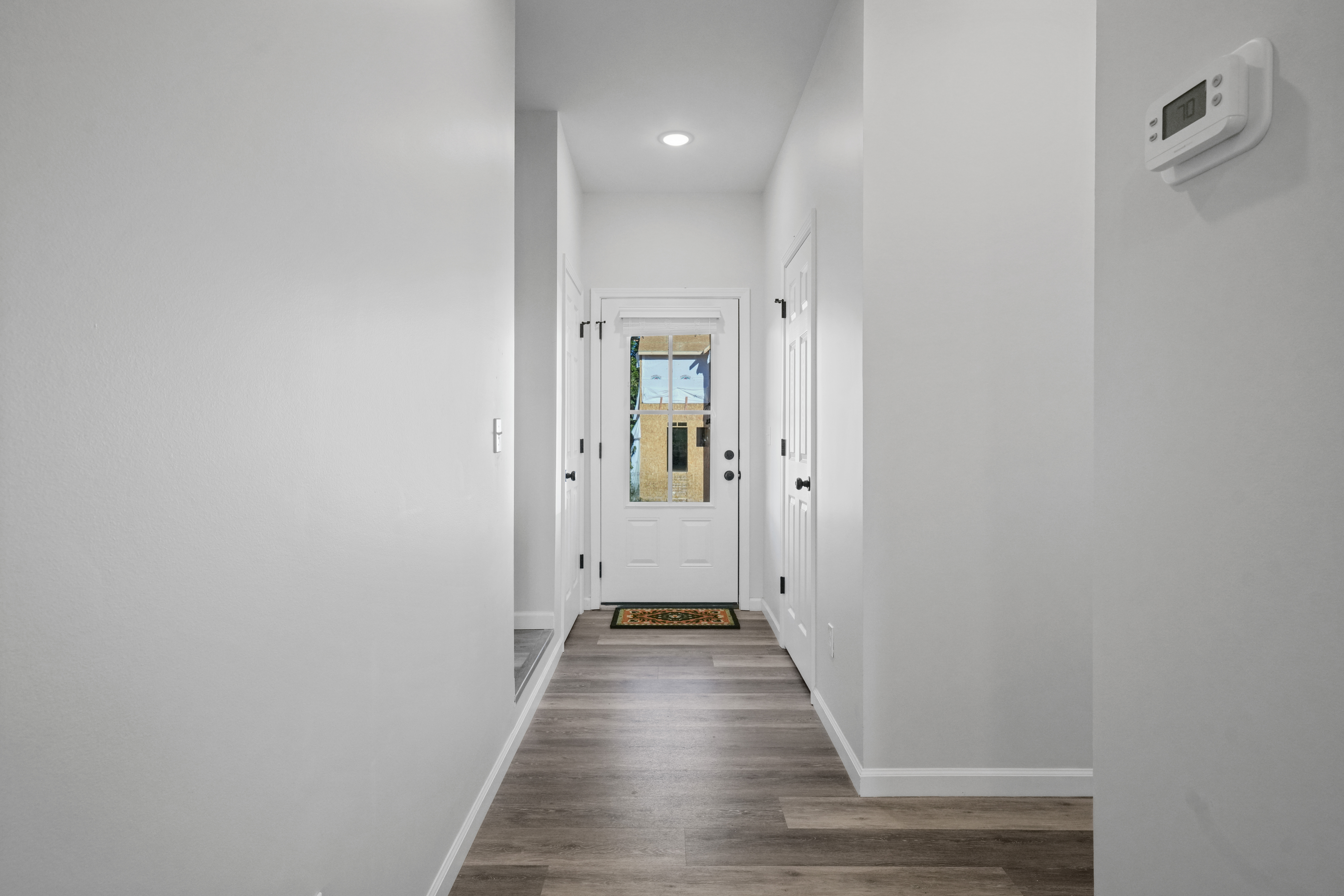 Bright modern entryway with wood-look floors and natural light