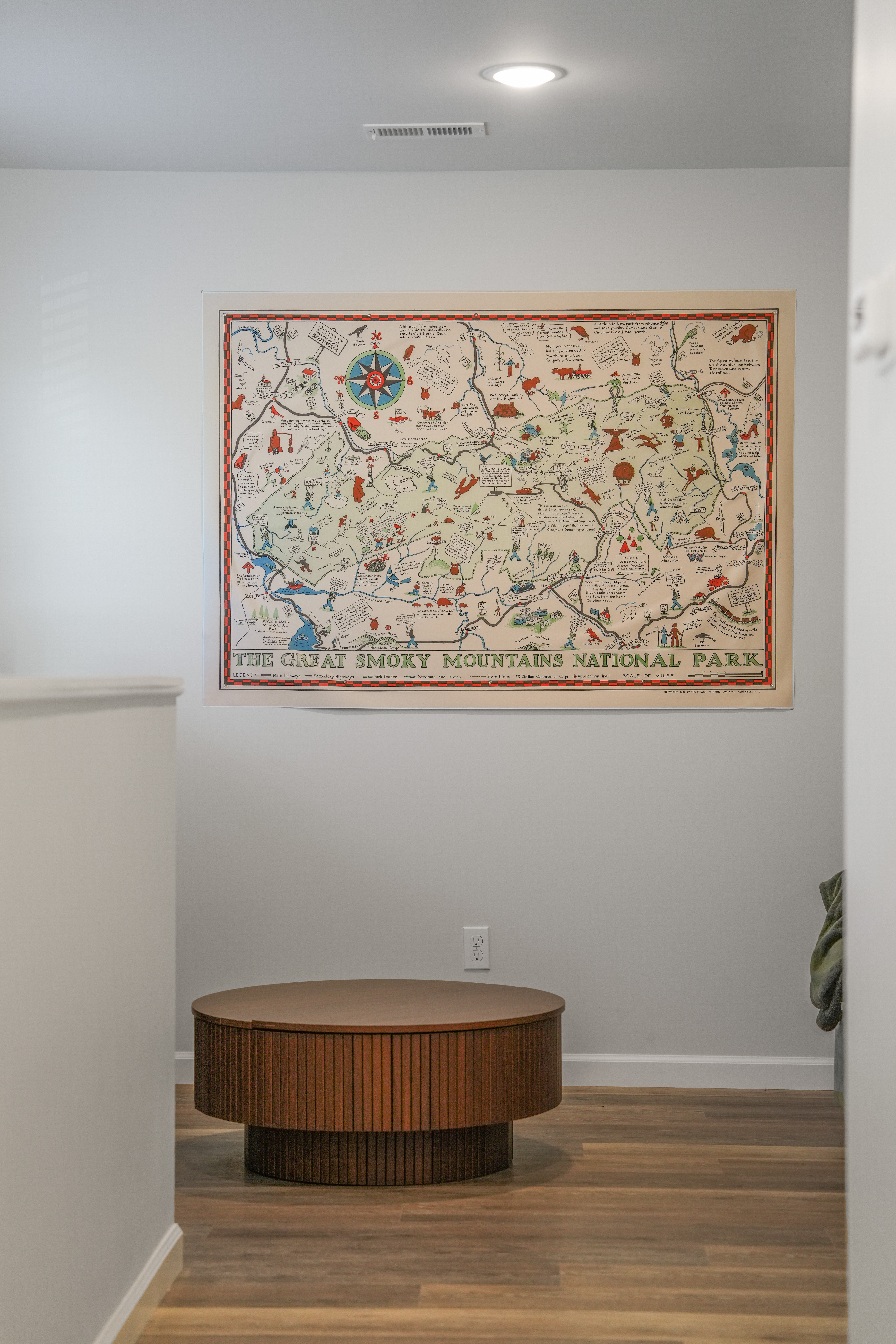 Chic entry nook with Smoky Mountains map and designer wood table