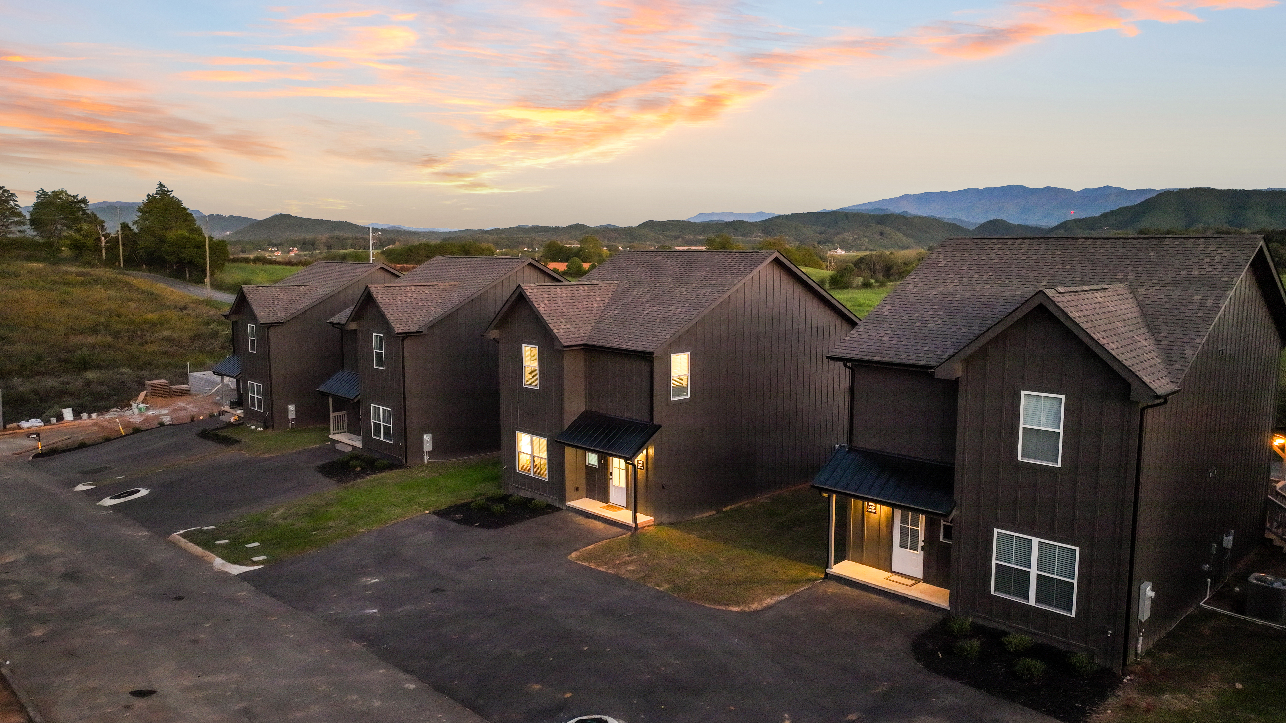Modern mountain-view homes with spacious parking at sunset